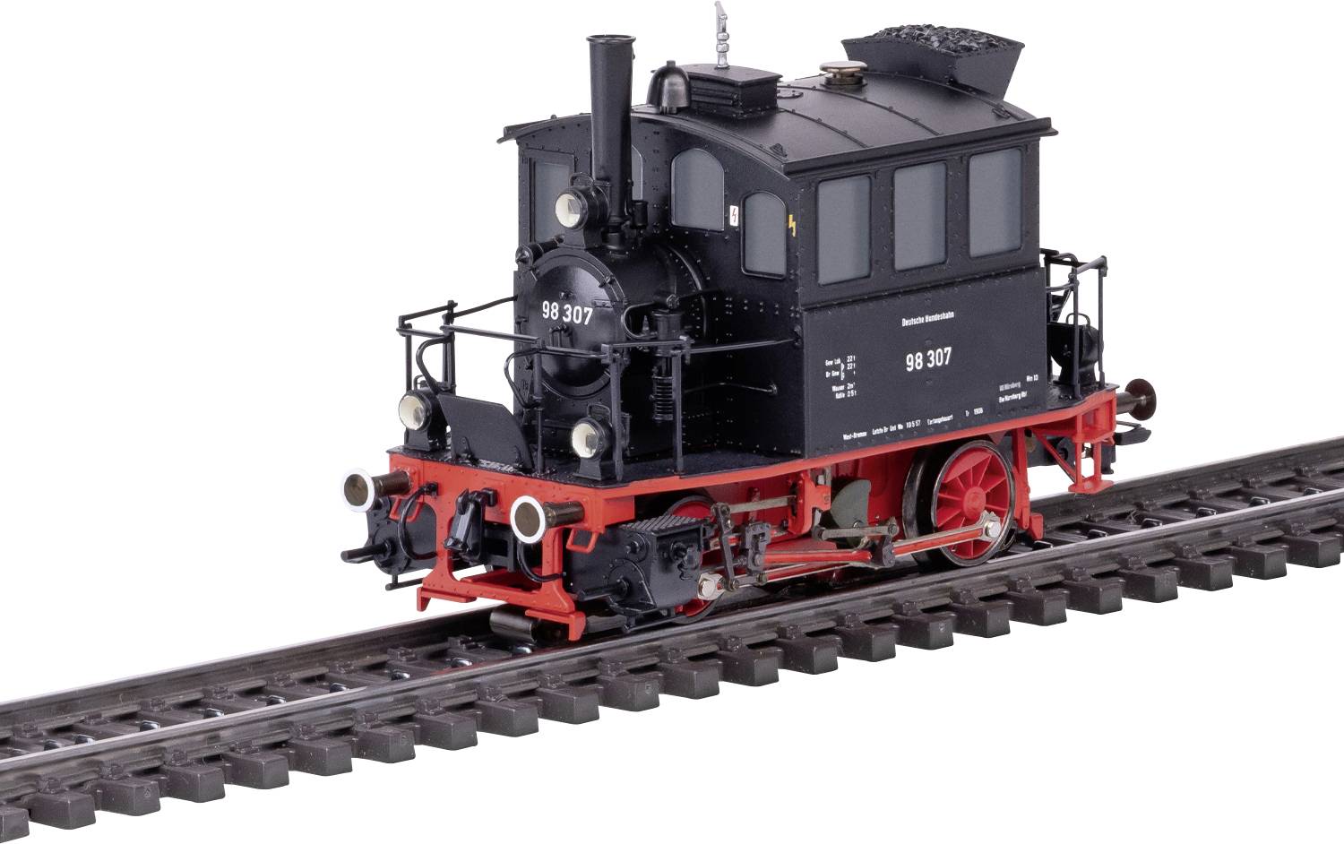 A small, vintage black steam locomotive with red wheels is displayed on railway tracks against a white background.