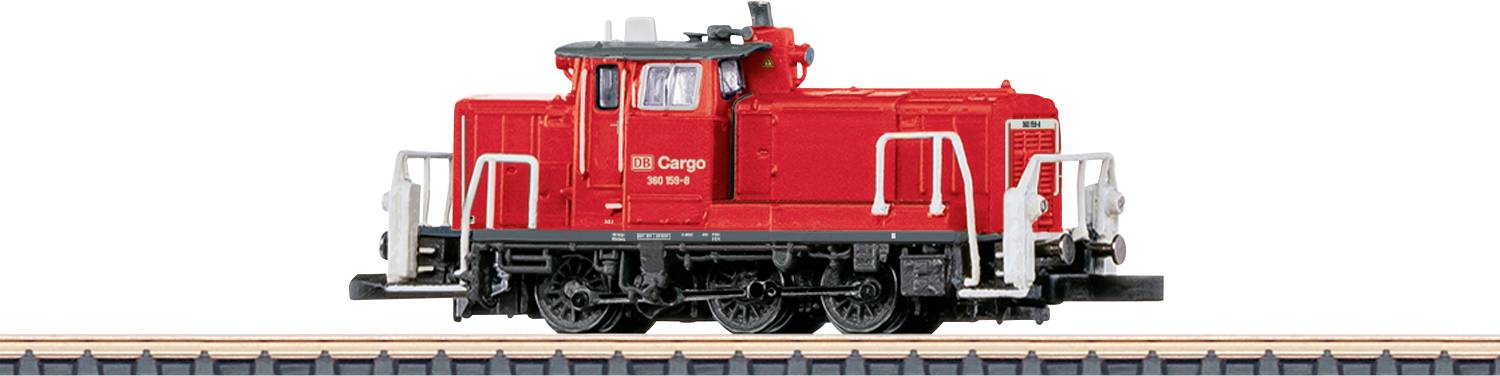 A red cargo train model on display, featuring detailed railings and wheels, situated on a short piece of track against a white background.