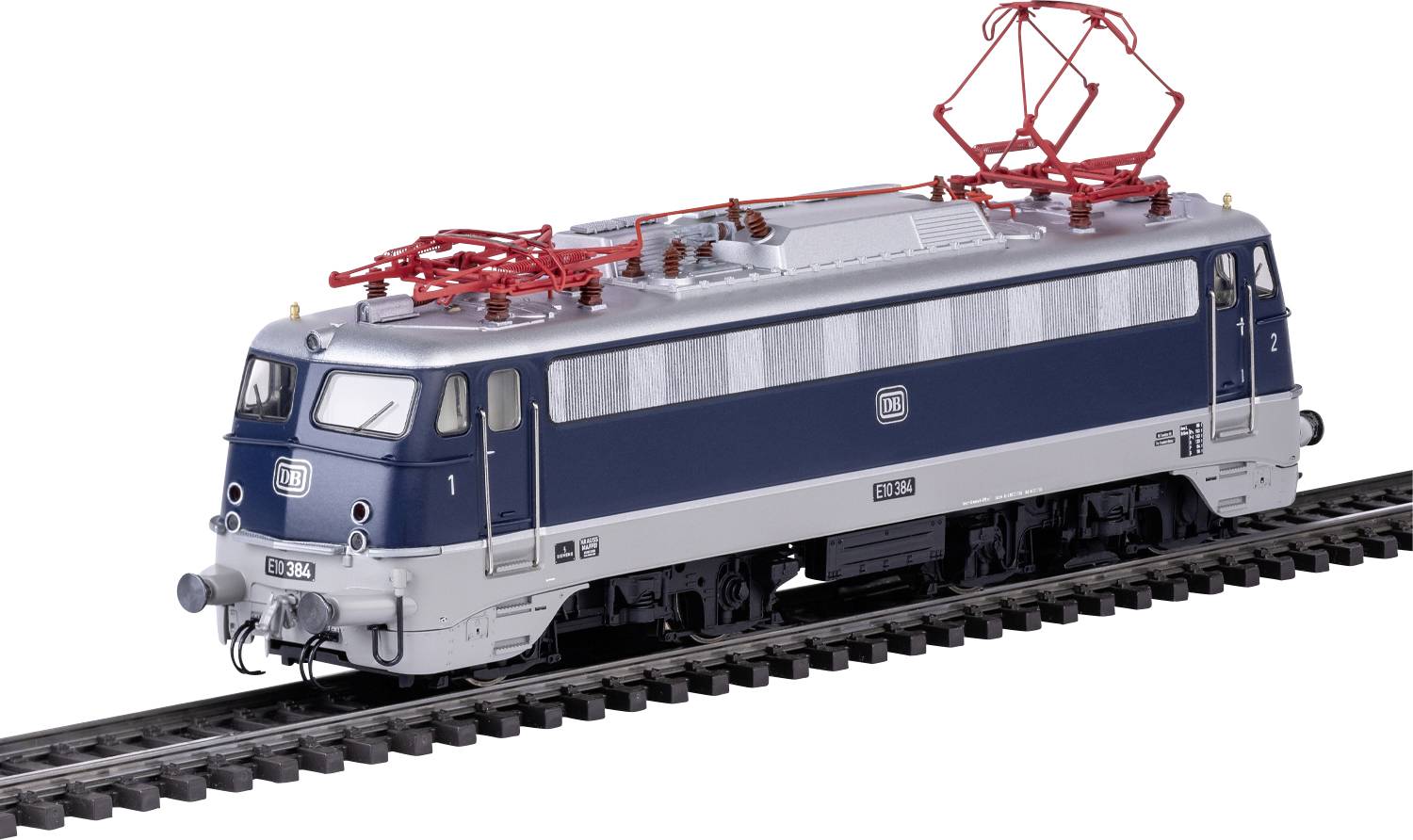 A model electric train with blue and silver detailing is shown on a black railway track, featuring red pantographs on top.