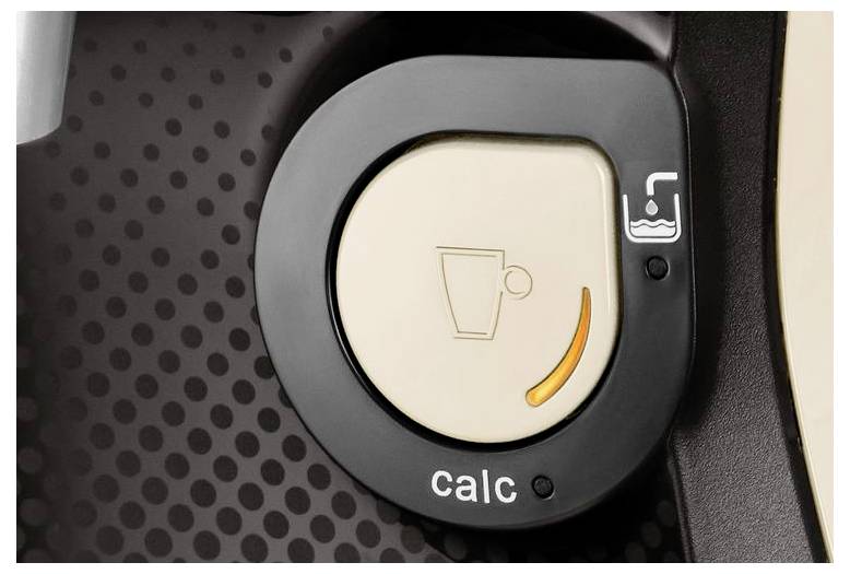 A close-up of a coffee machine's descaling indicator, displaying a cup icon and the word 'calc' with a yellow bar indicating the need to descale.