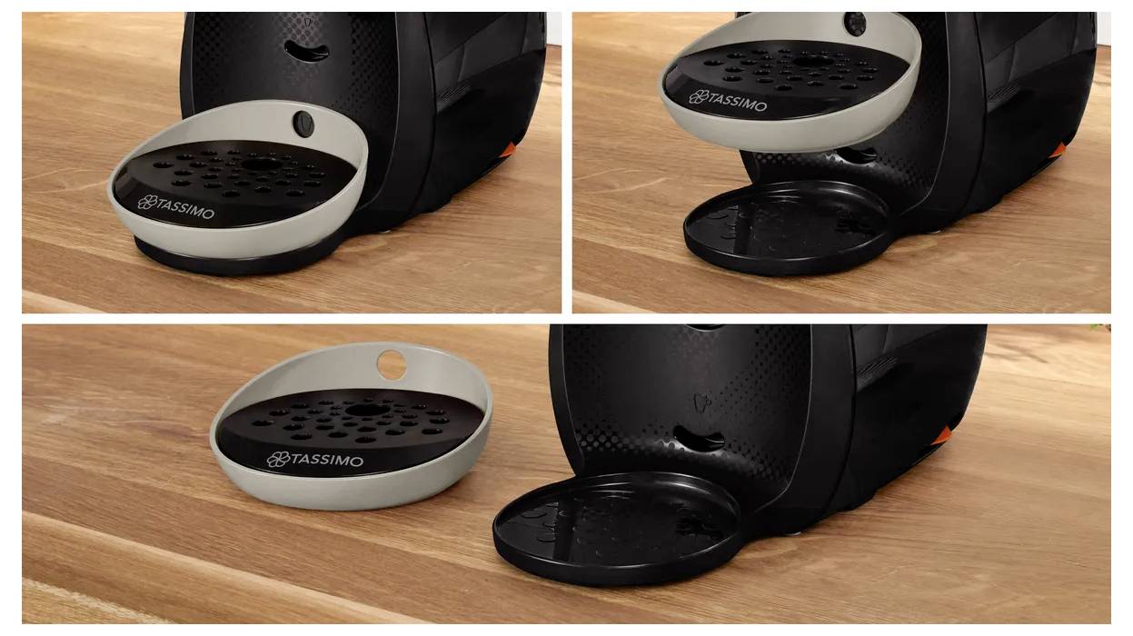 Coffee machine with a removable drip tray in beige and black variations on a wooden countertop.