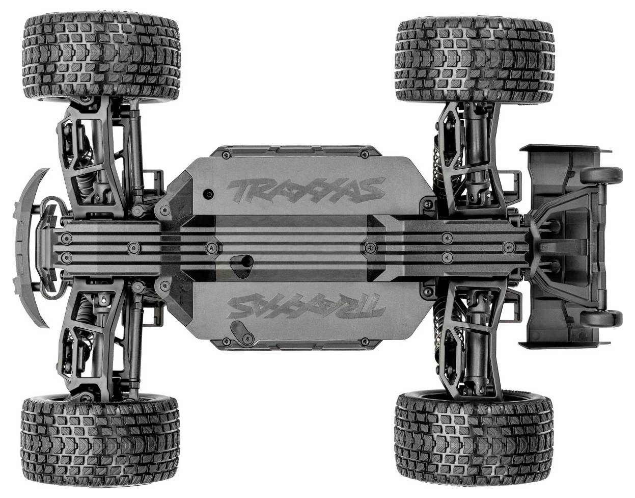 The image shows the underside of a remote-controlled vehicle with rugged tires and a detailed suspension system, highlighting its off-road capabilities.