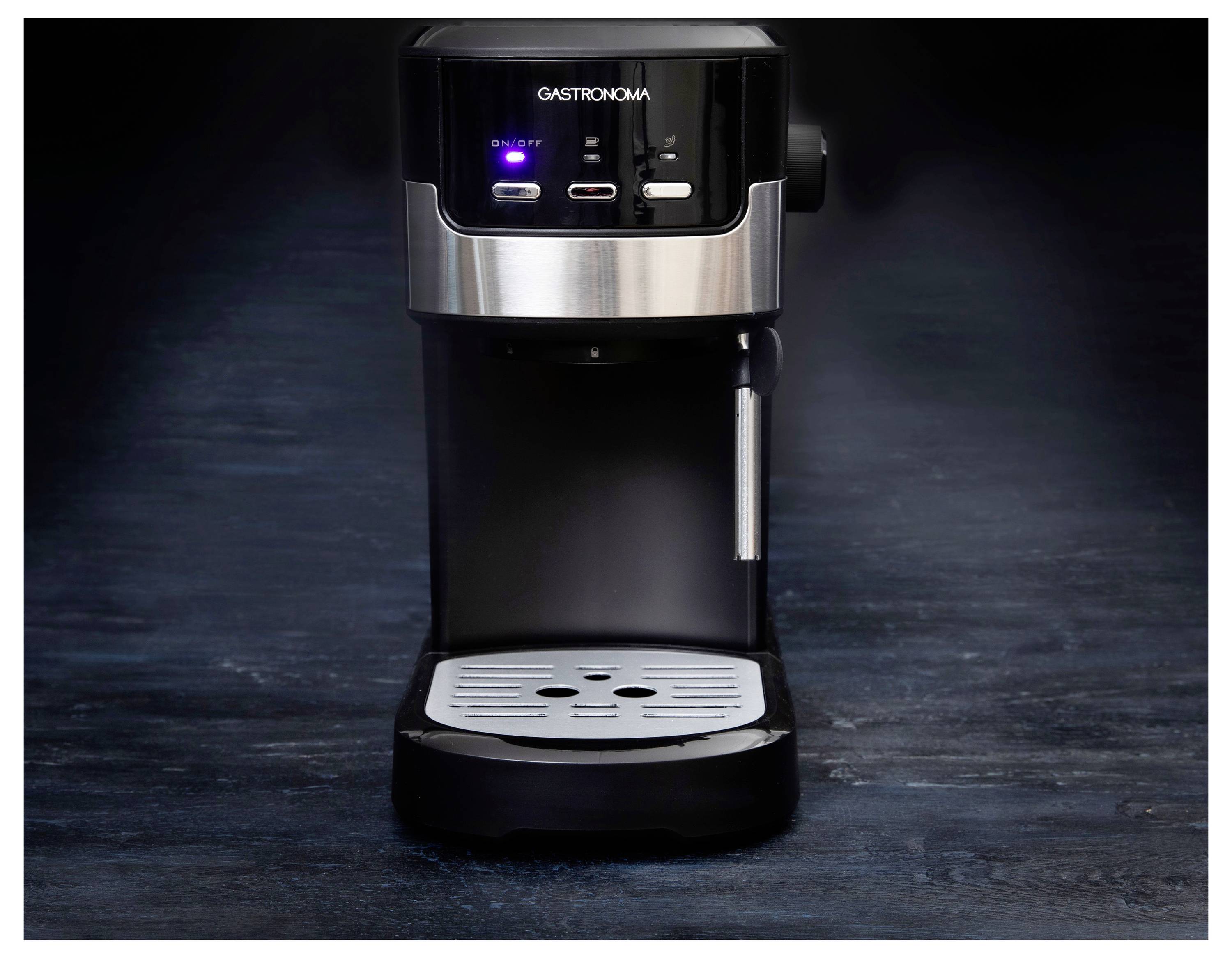 A black espresso machine on a dark surface, displaying buttons and a drip tray.