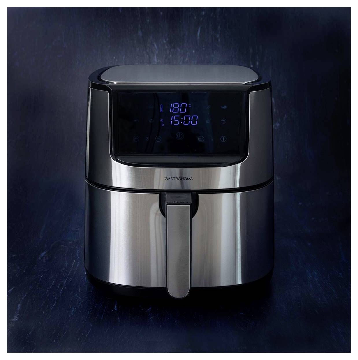 A digital air fryer with a sleek chrome finish displays '180°C' and '15:00' on its touch screen, set against a dark background.