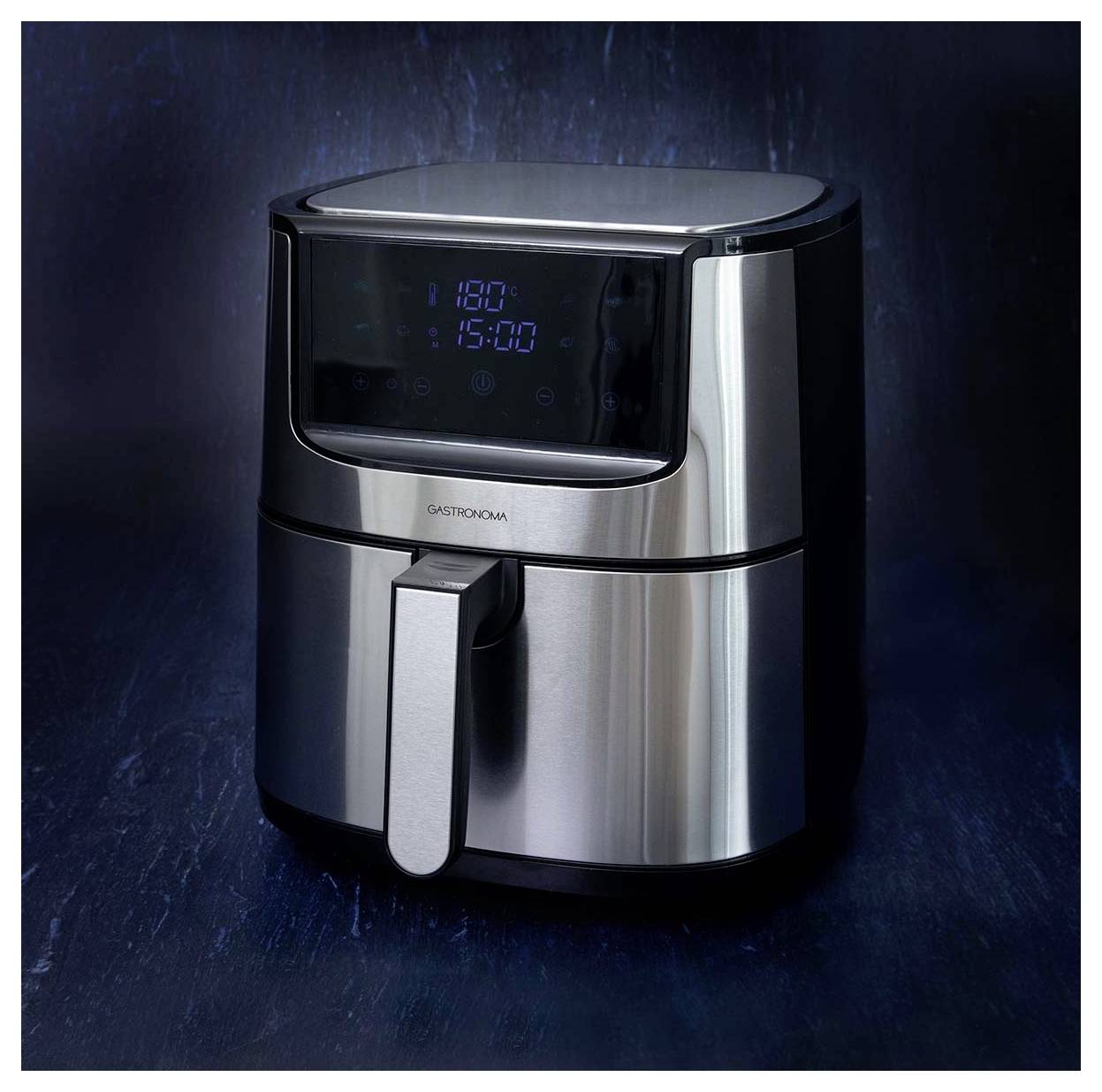 A sleek, modern stainless steel air fryer with a digital display showing '180°C' and '15:00' sits on a dark background.
