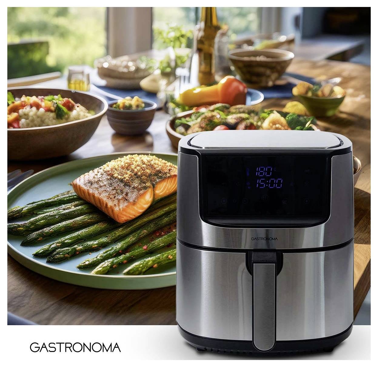 'GASTRONOMA air fryer' in foreground, salmon and asparagus on a plate, assorted dishes blurred in background on a dining table.