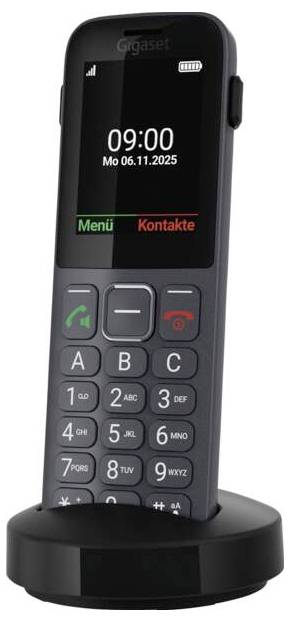 A cordless phone with a keypad and digital screen displaying '09:00 Mo 06.11.2025'. It is mounted on a charging base.