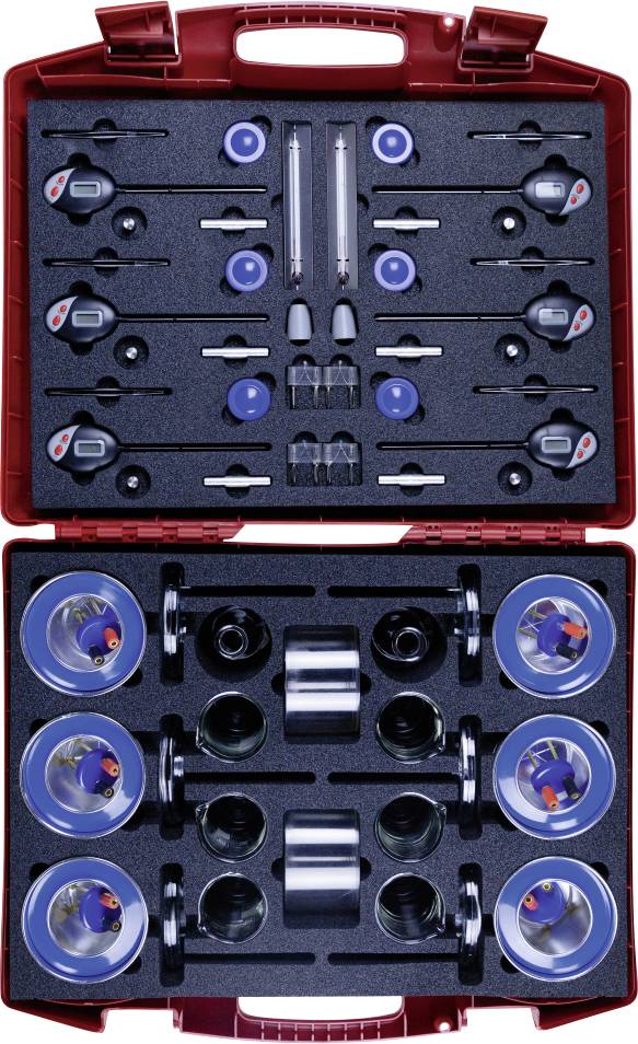 A red case containing precision weight sets and calibration equipment, organized in compartments for measuring and calibration purposes.