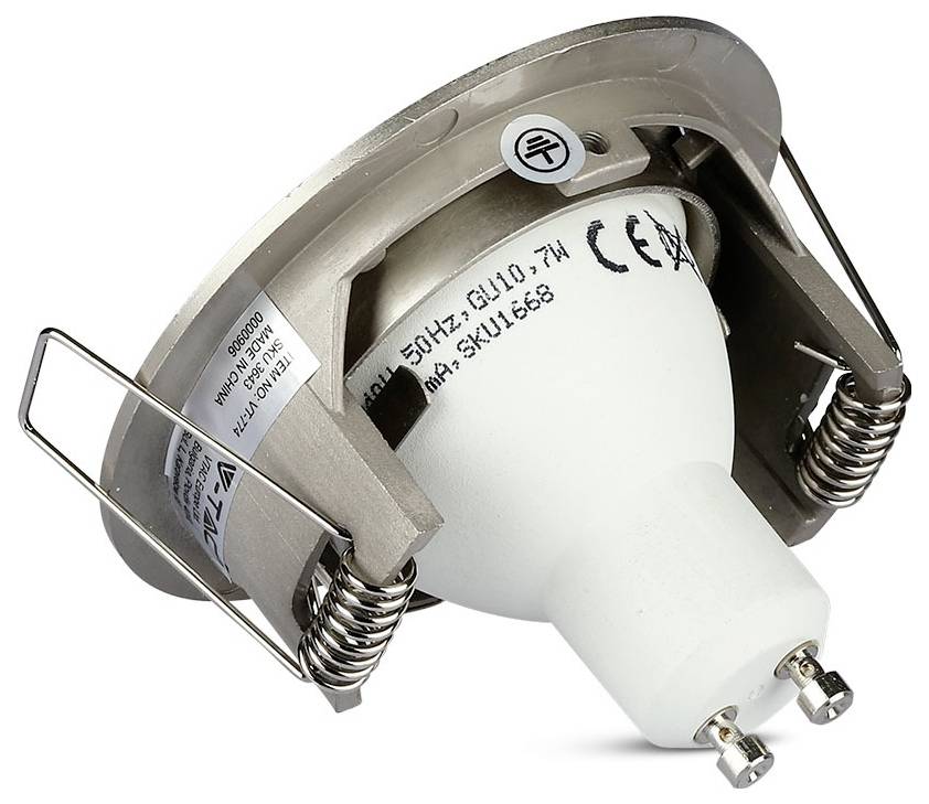 Recessed metal spotlight fitting with two spring clips, showing a white GU10 bulb mounted inside. Label indicates CE certification.
