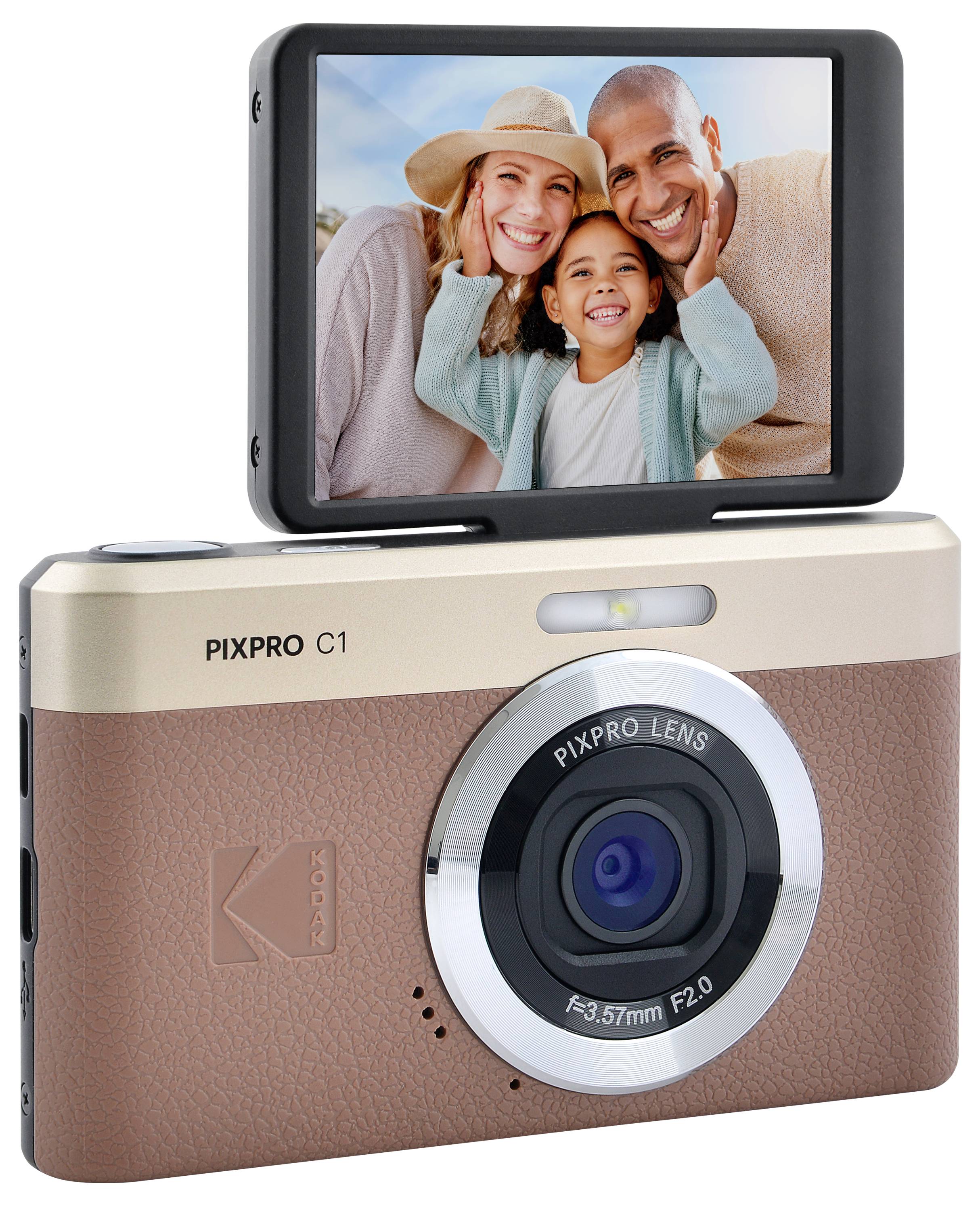 A digital camera with a flip-up screen showing a smiling family of three taking a selfie; the camera has a brown and silver design.