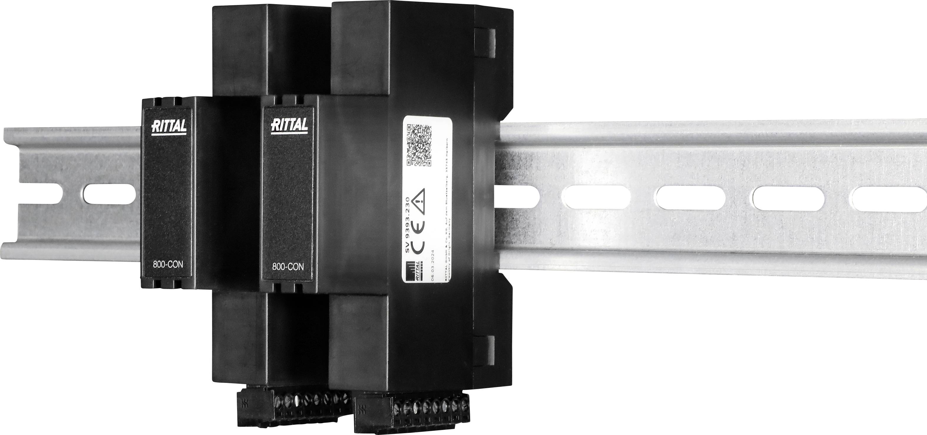 'Rittal' busbar system mounted on a metallic rail, featuring connectors and labels, used for electrical distribution and management.