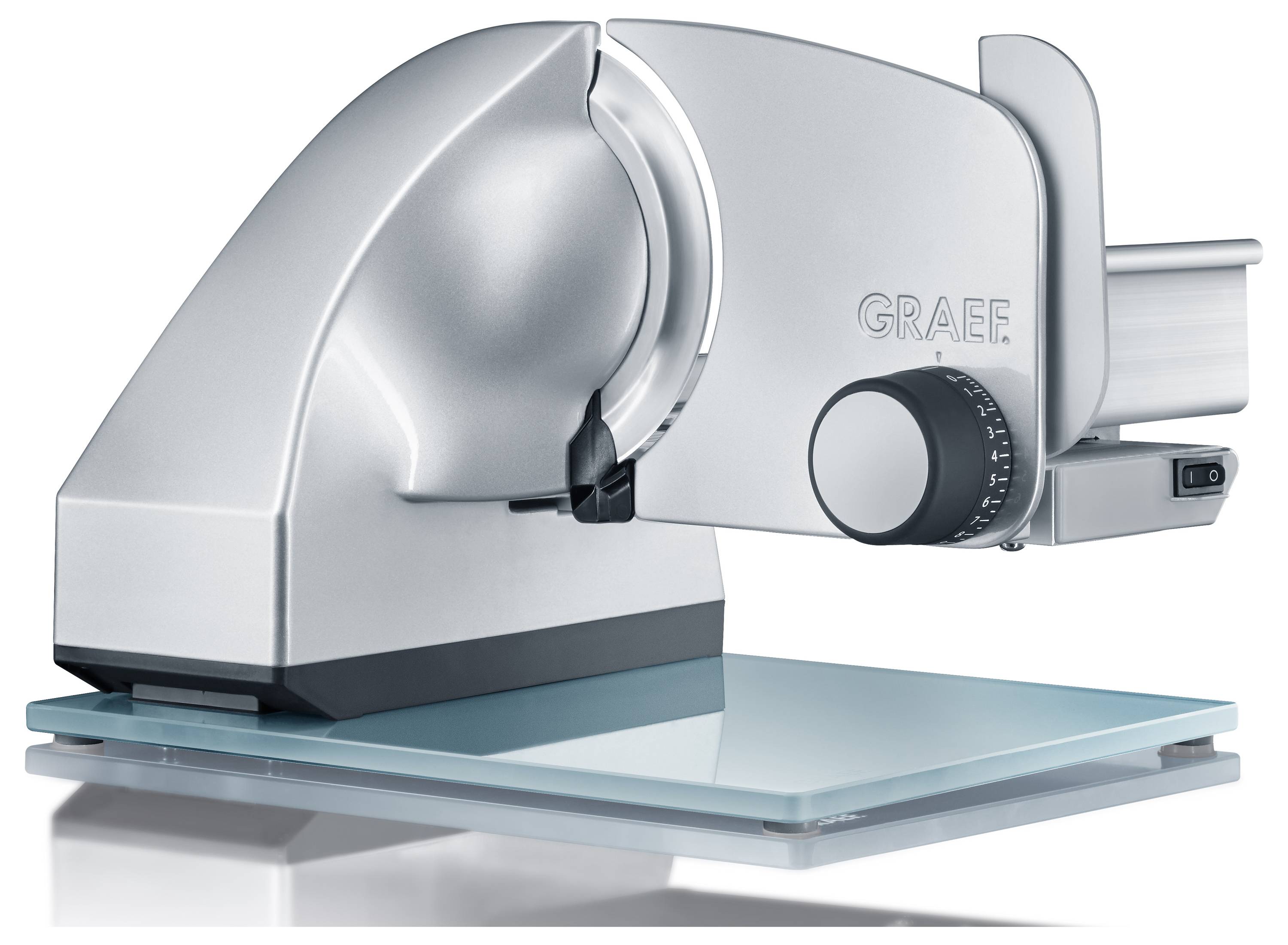 A sleek, silver electric food slicer on a glass base with an adjustable thickness dial, designed for precise slicing of meats and bread.