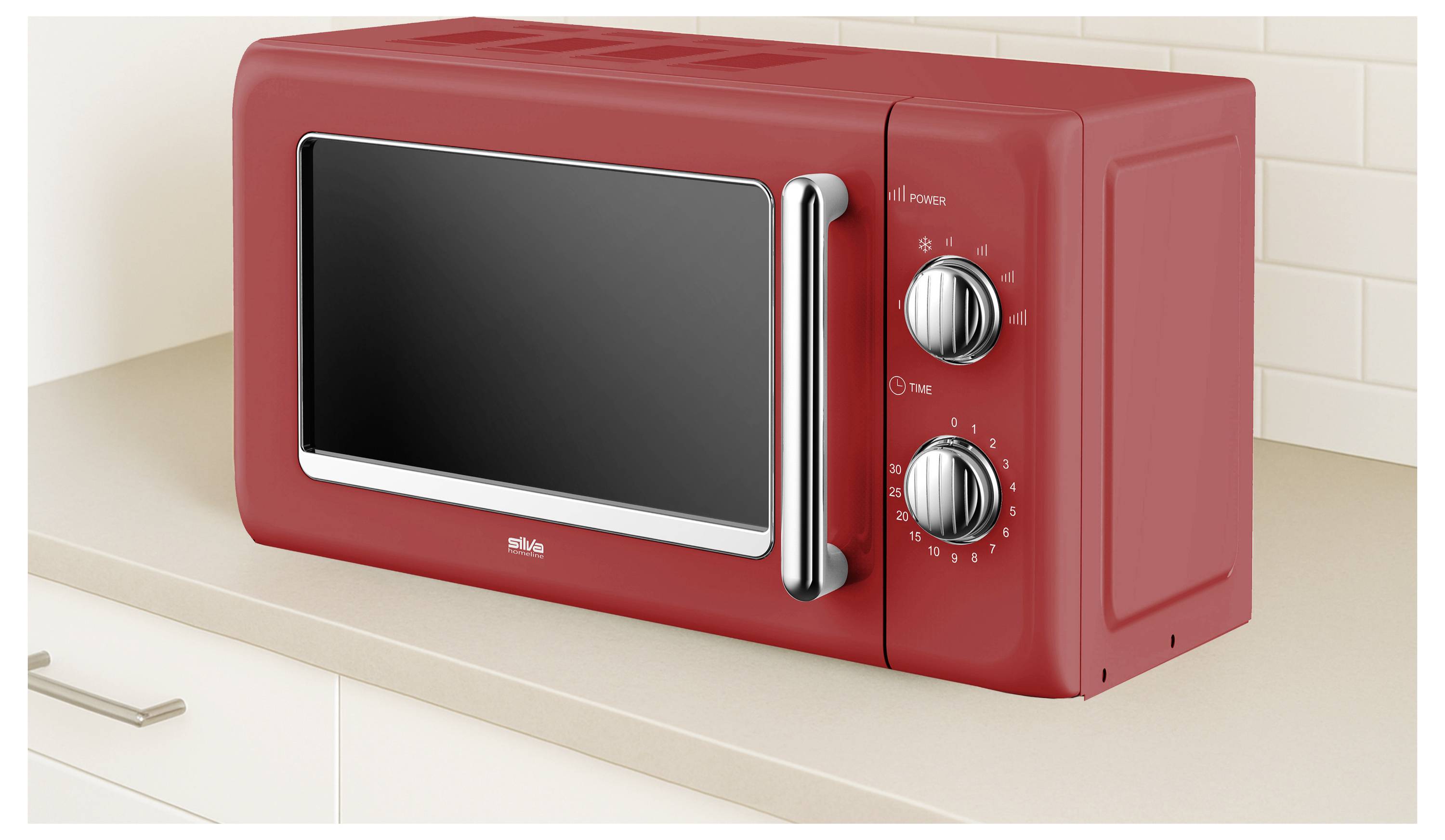A red microwave with two control knobs, placed on a beige kitchen countertop against a tiled wall.