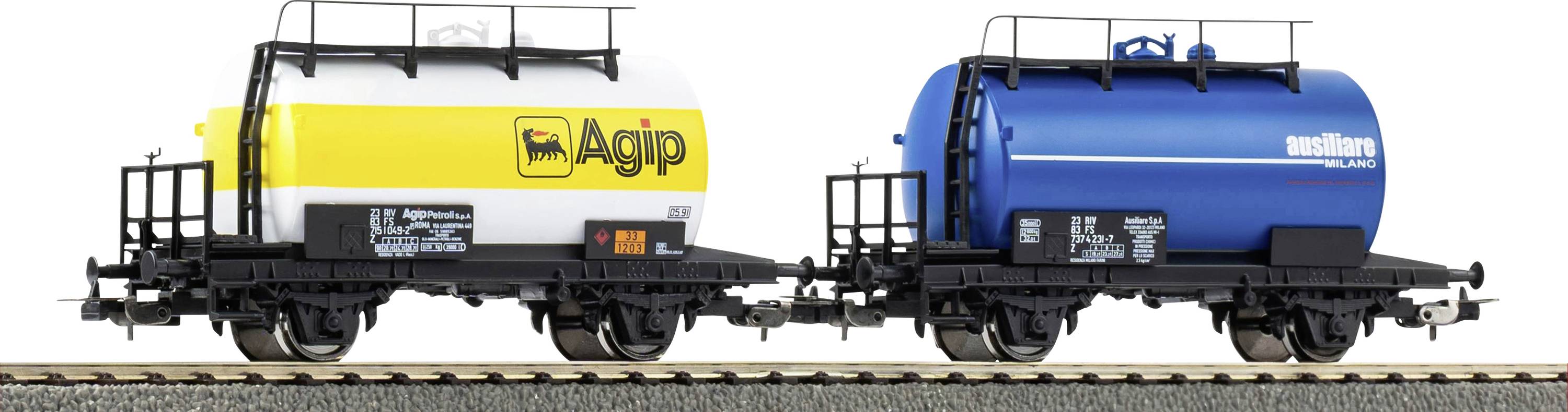 Two model train tanker cars on tracks; the first is yellow and white marked 'Agip,' and the second is blue labeled 'Wascosa.'
