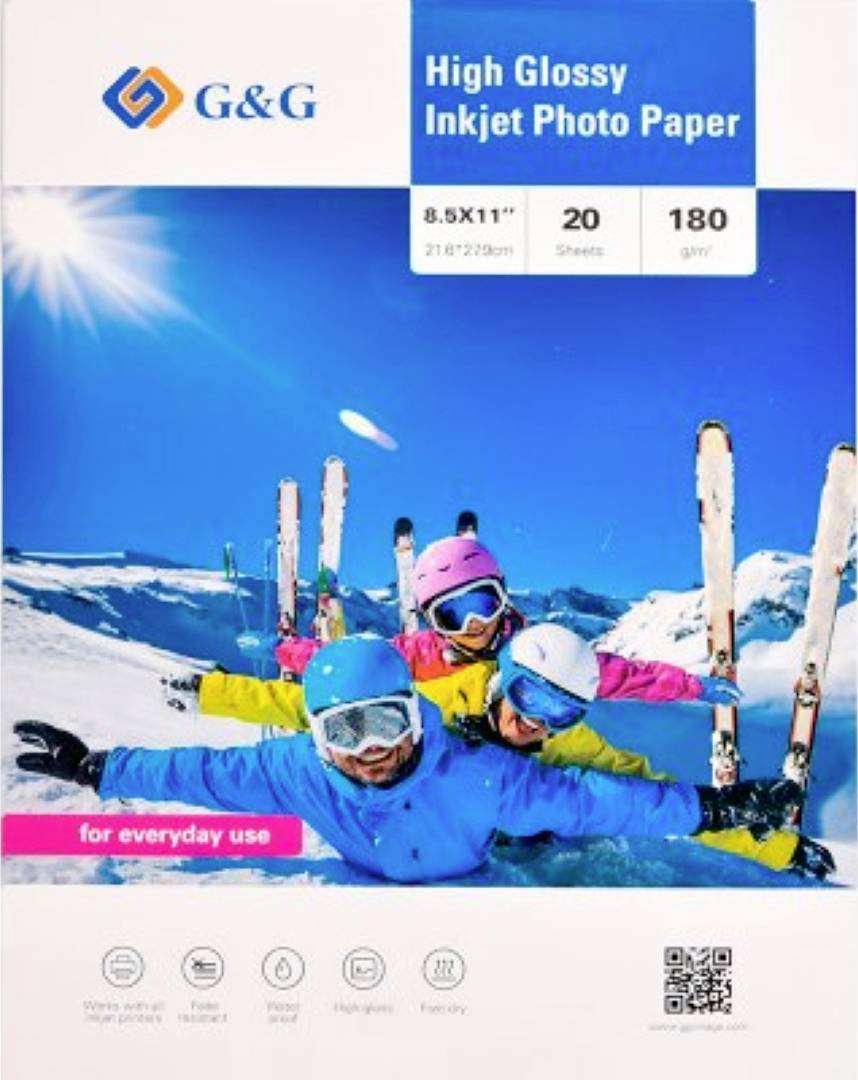 A group of skiers in colorful outfits lies on the snow, smiling, with skis in the background. 'High Glossy Inkjet Photo Paper' branding.