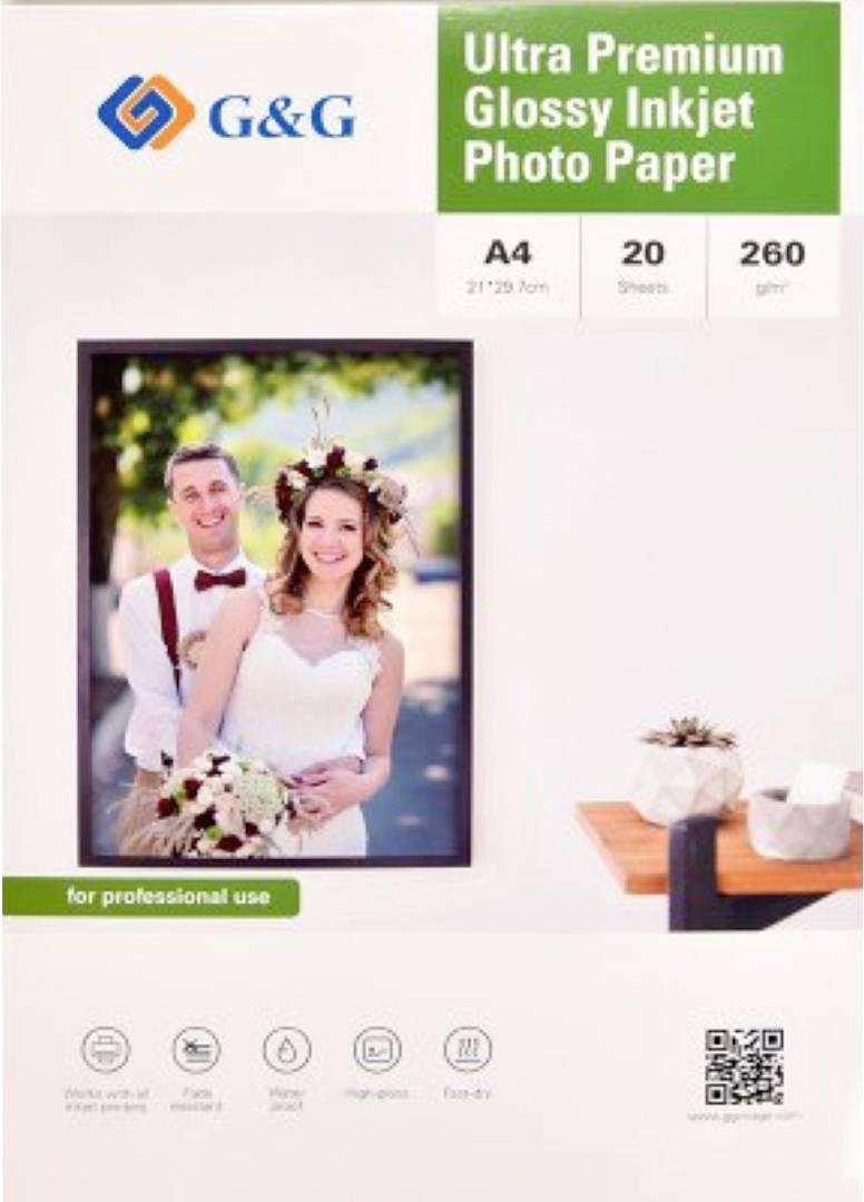 A package of 'G&G Ultra Premium Glossy Inkjet Photo Paper' featuring a smiling couple in wedding attire. Contains 20 A4 sheets, 260g/m², for professional use.