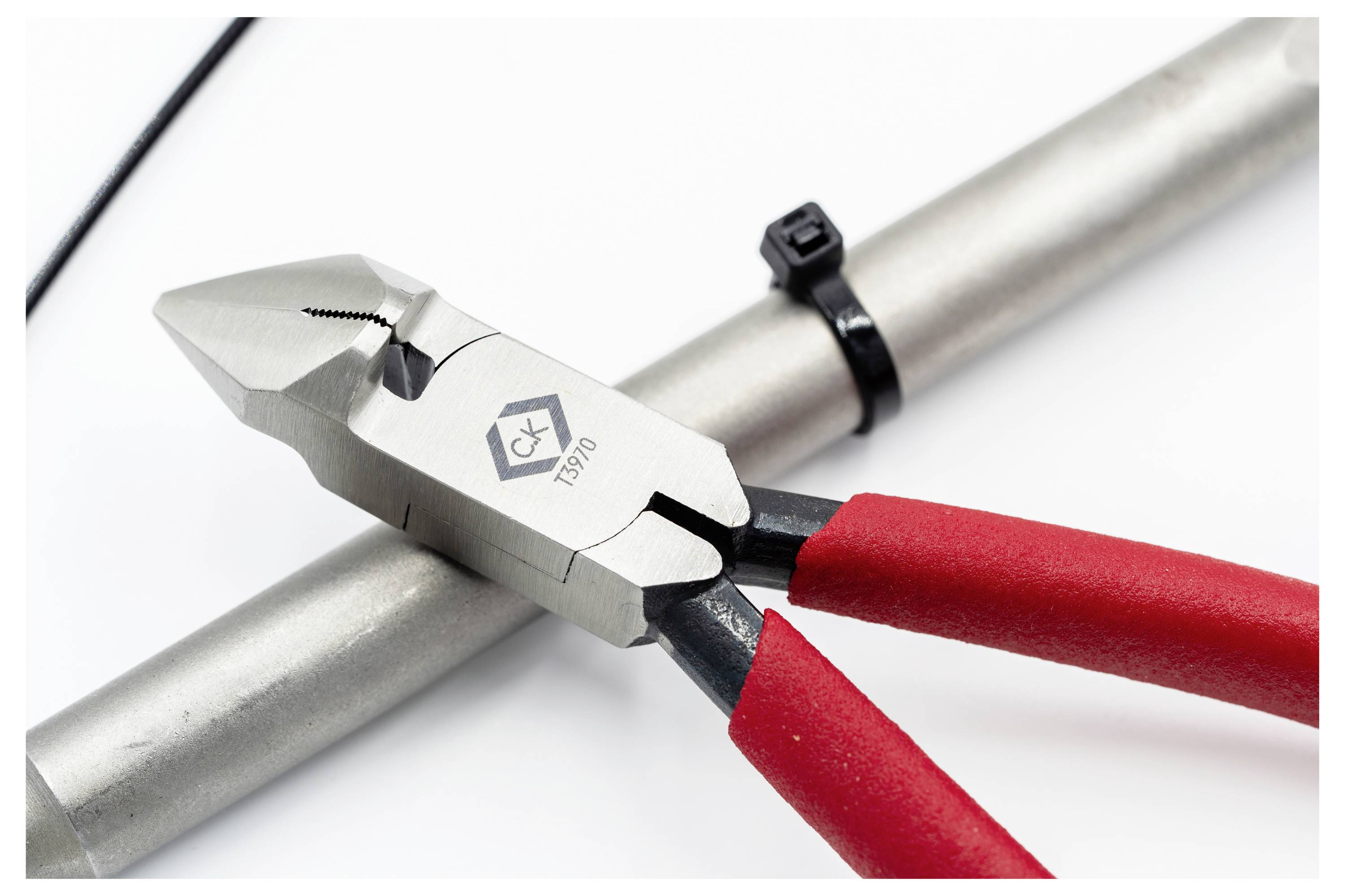 'Red-handled wire cutters cutting a black cable tie on a silver metal pipe, with a visible manufacturer's logo.'