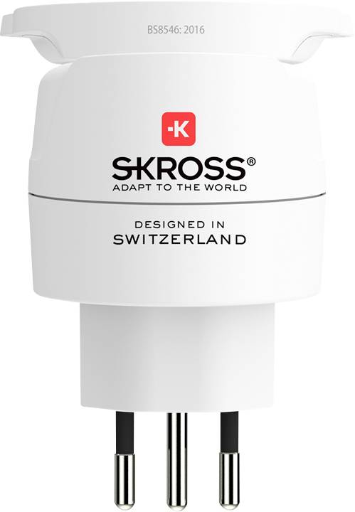 A white SKROSS travel adapter with three prongs, labeled 'Adapt to the World'. Designed in Switzerland.