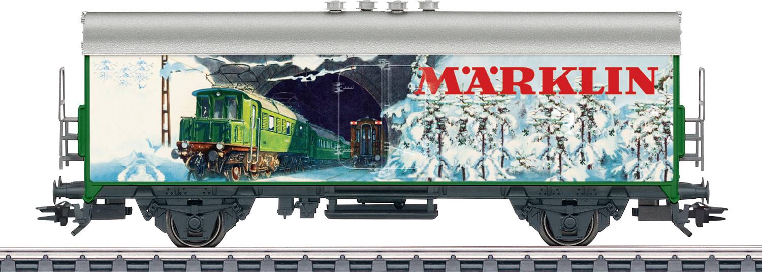 A model train car featuring a snowy mountain landscape with a green train emerging from a tunnel. The name 'MÄRKLIN' is prominently displayed on the side.