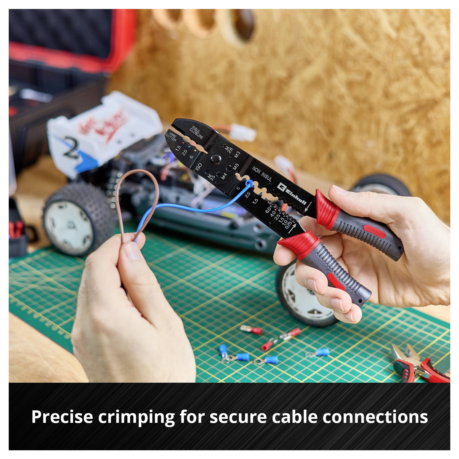 A hand holds a wire and a crimping plier; in the background a model car. Text: Precise crimping for secure connection of conductors.