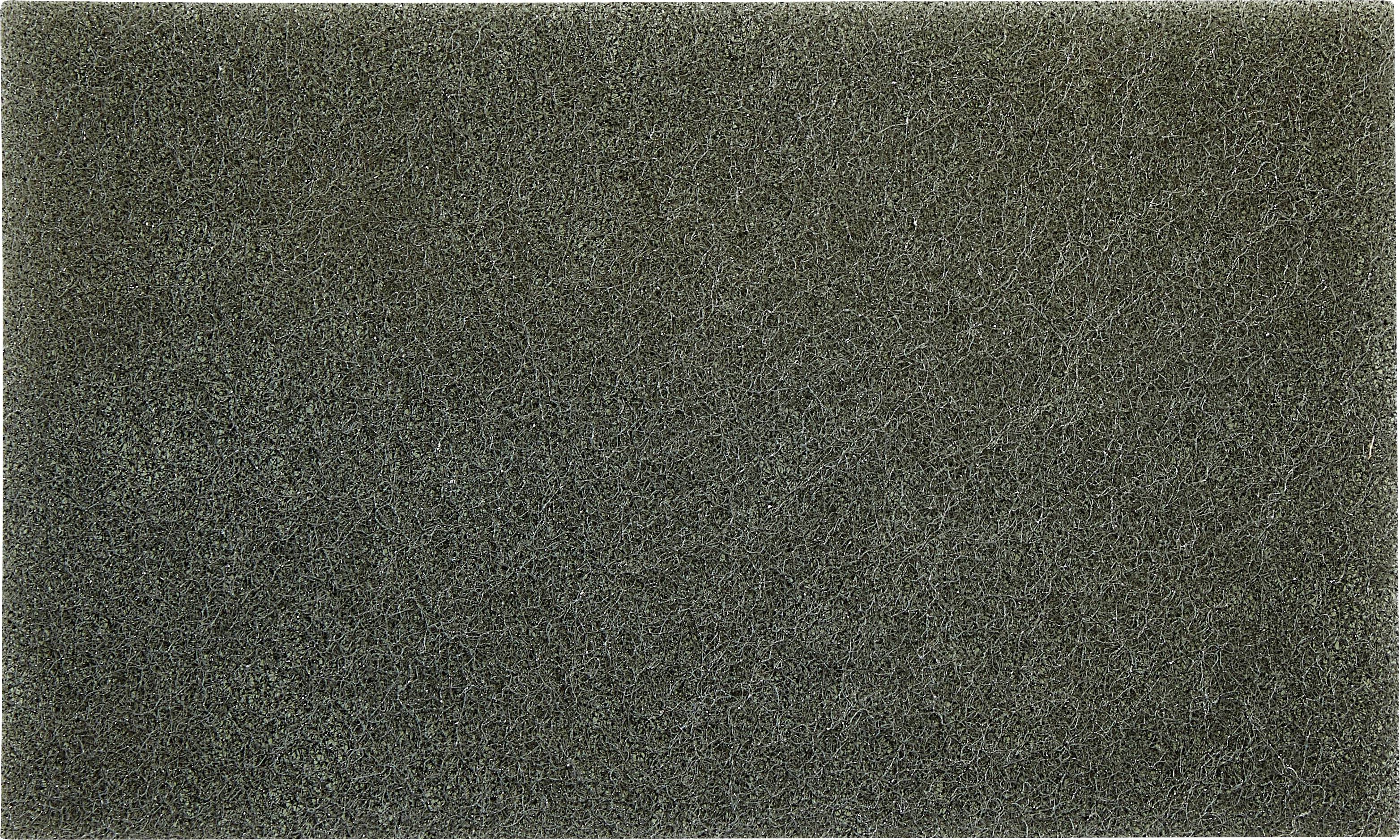 A coarse, dark grey rectangular scouring pad with a fibrous texture.