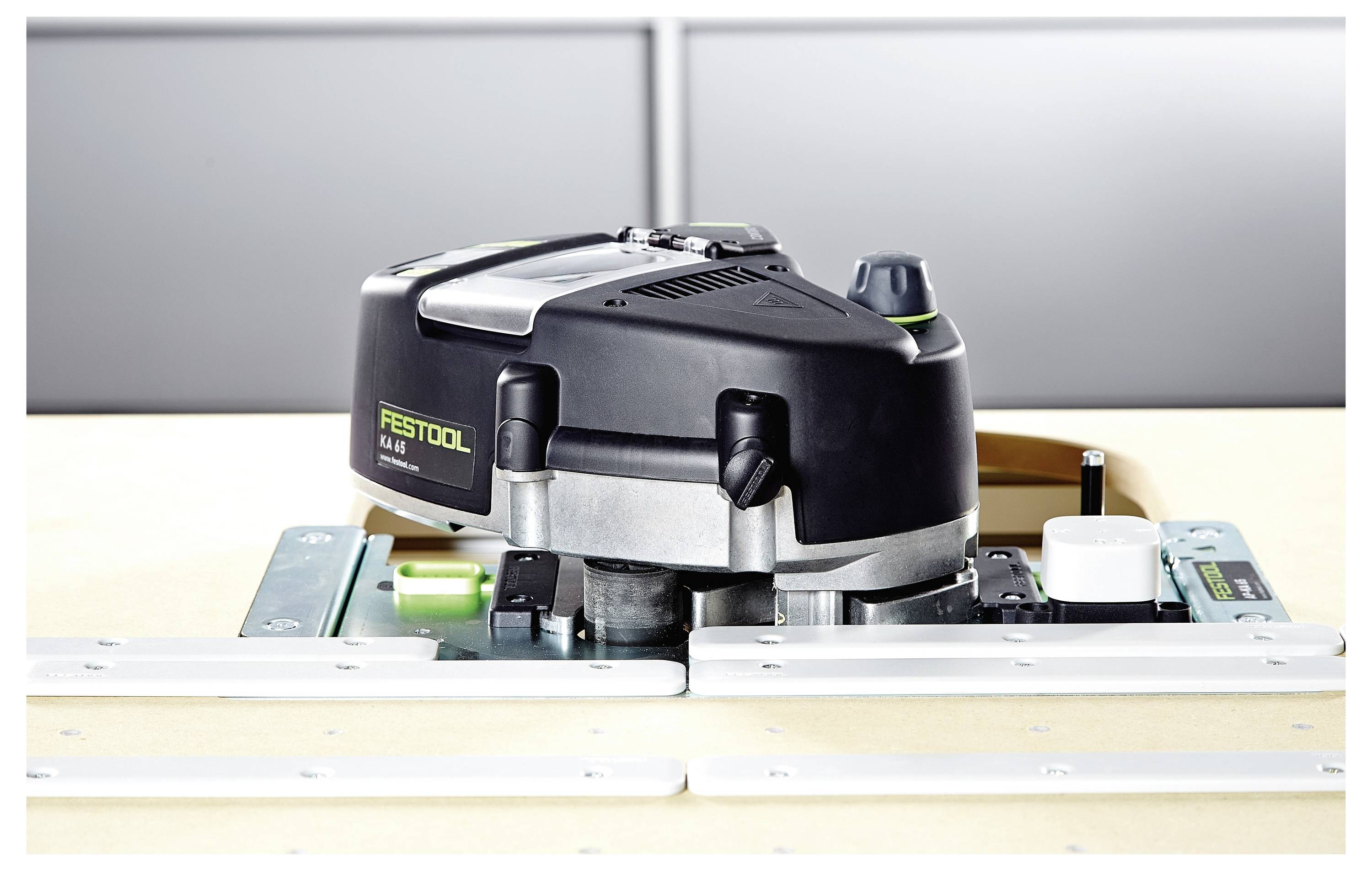 A Festool router placed on a workbench, showing its top view with visible controls and branding, set up for precise woodworking tasks.