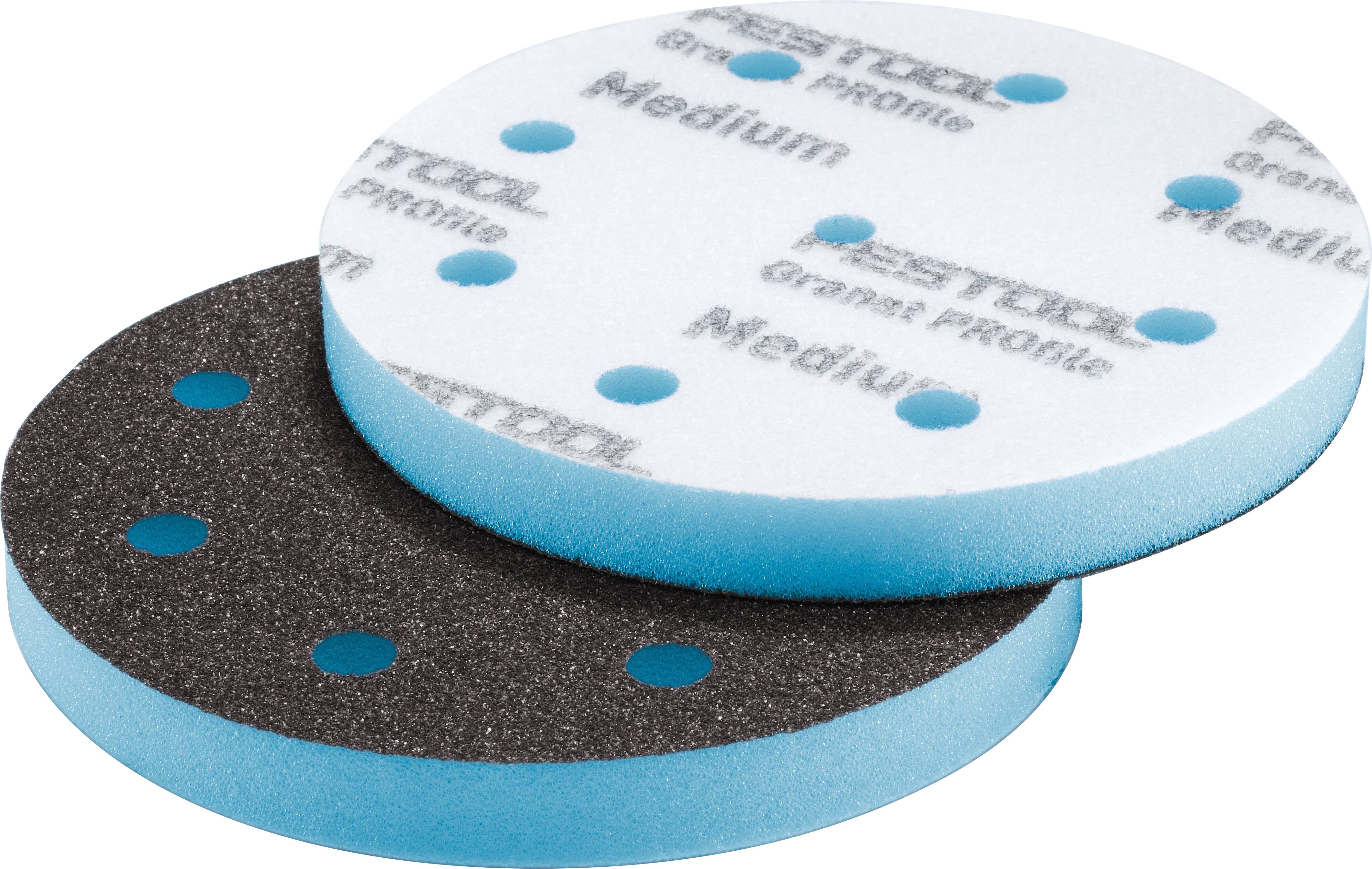 Two circular, layered sanding pads. One is white with 'Medium' text and blue spots; the other is black with blue spots, indicating different textures.
