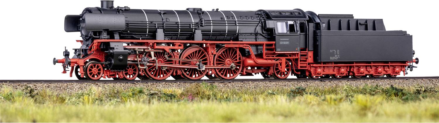 A model steam locomotive with a black body and red wheels is displayed on a track with grass. The train is detailed and realistic.
