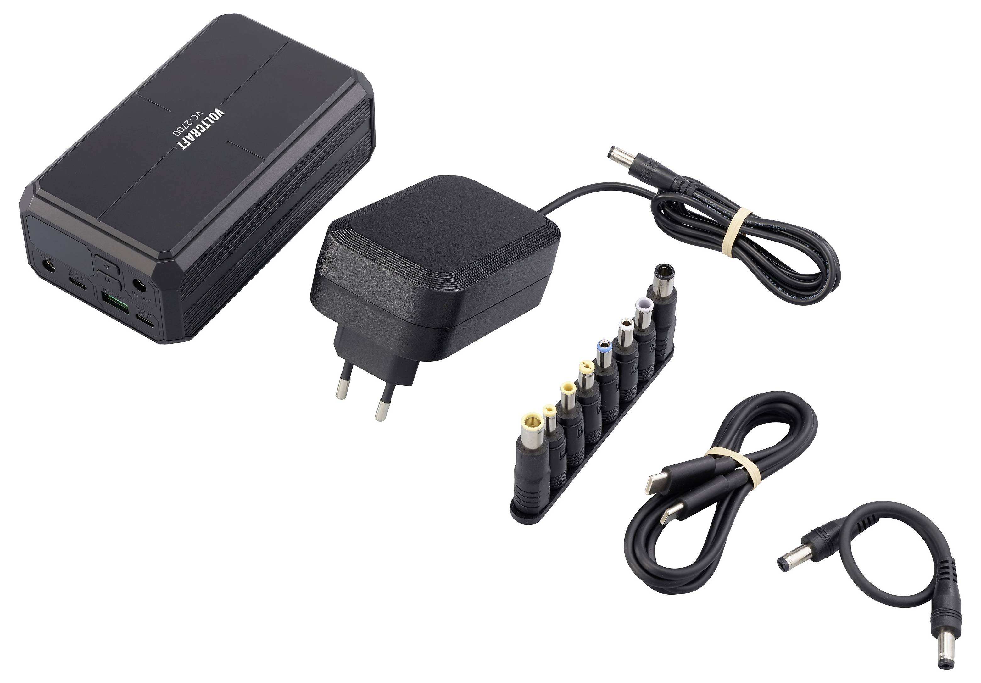 Universal AC adapter with interchangeable plug tips and multiple DC cables for charging devices.