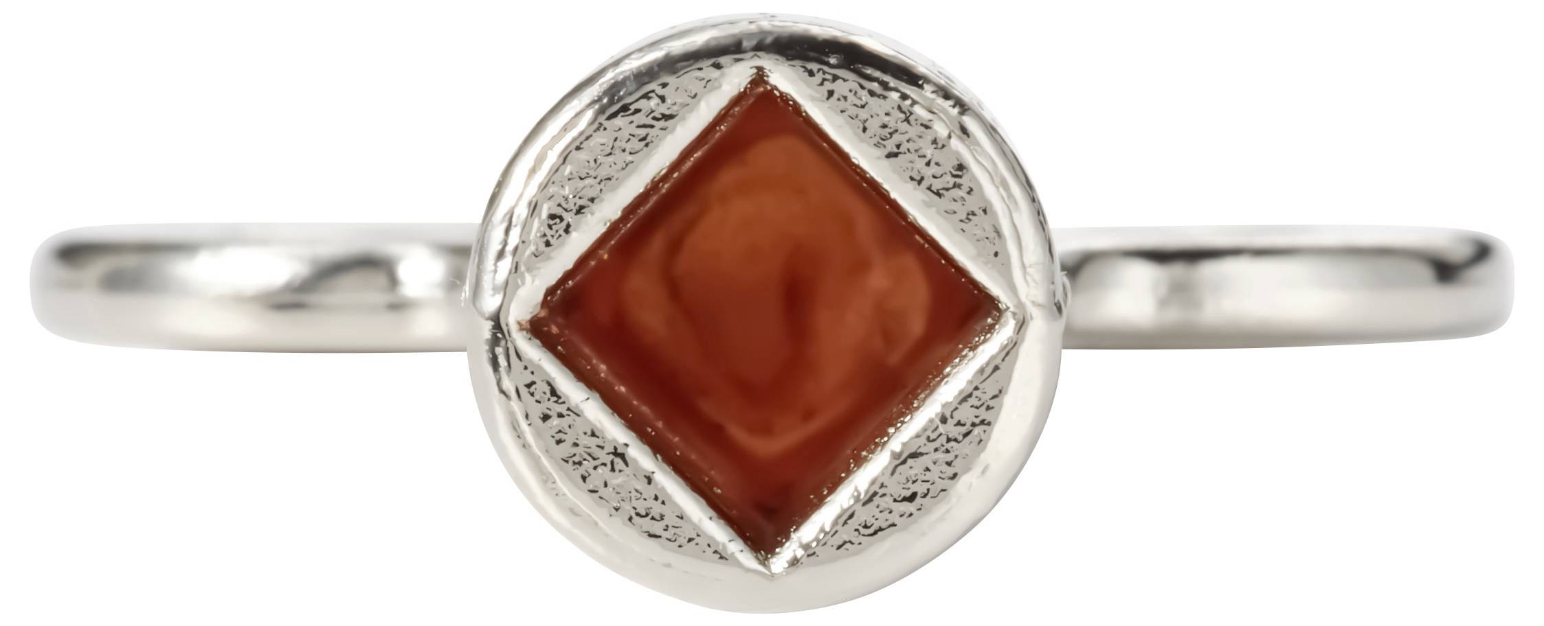 Silver ring with a central red diamond-shaped gemstone set in a round bezel.