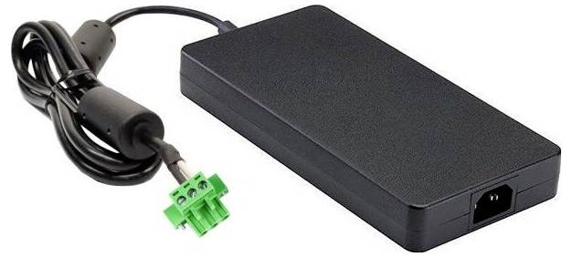A black rectangular power adapter with a connected cable ending in a green plug.