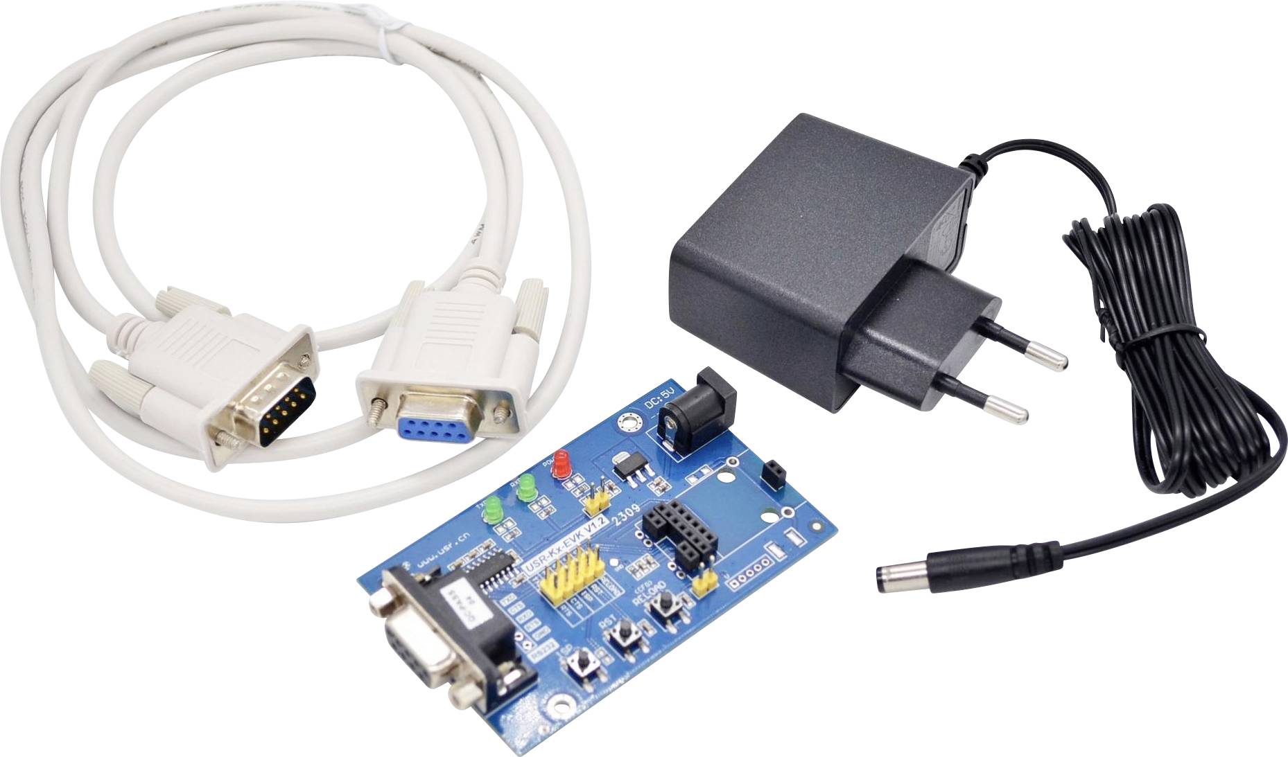 Electronics set including a DB9 serial cable, power adapter, and a blue circuit board featuring various connectors and components.