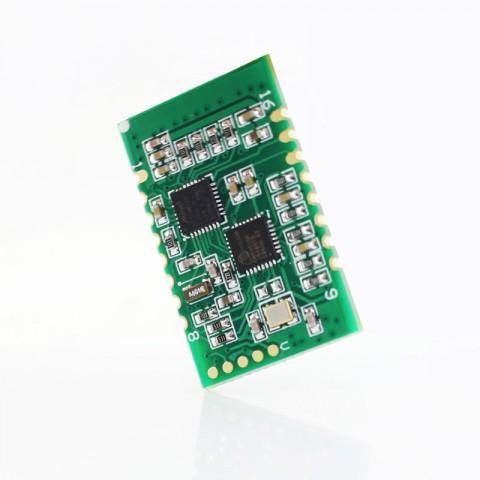 A small, green circuit board with multiple microchips and components, viewed against a plain white background.