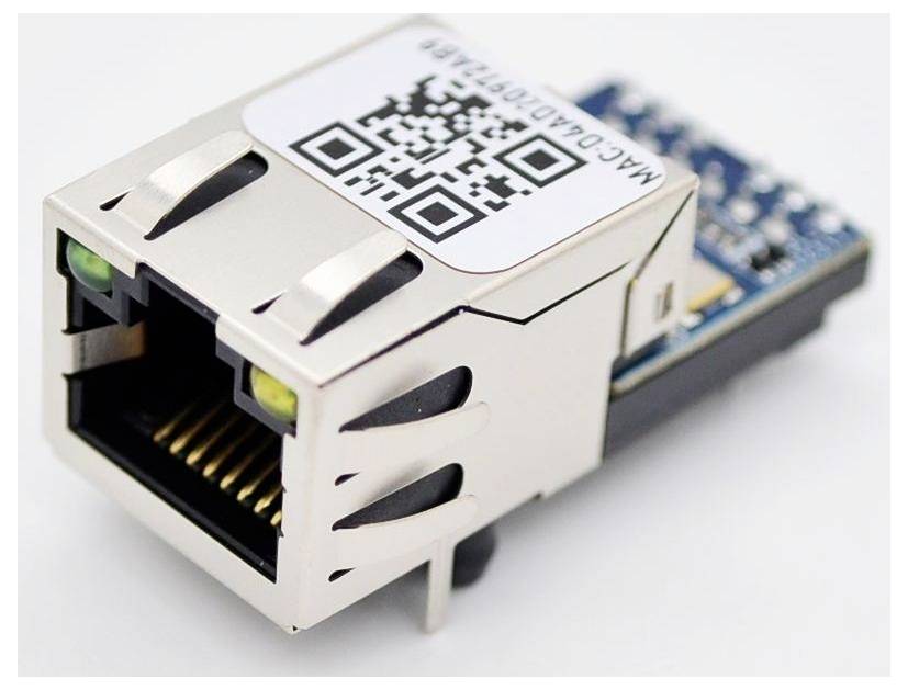 An Ethernet module featuring a metal RJ45 connector, with a QR code and text label on top, used for networking in electronic projects.