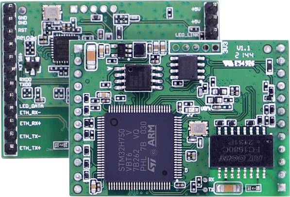 Two green printed circuit boards with microchips, labeled 'ARM', showing various electronic components and connections.