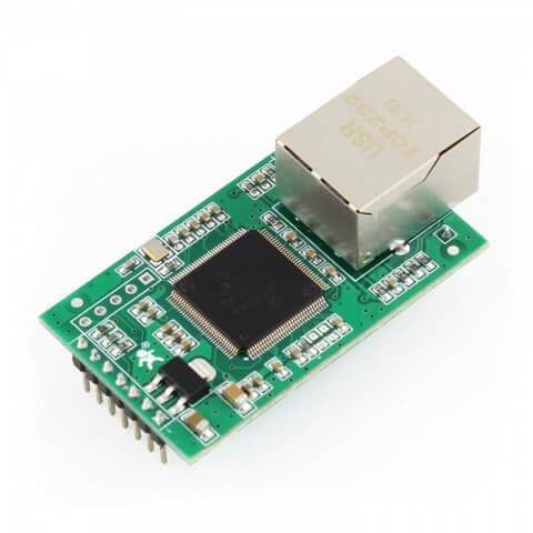 A green circuit board with a prominent black chip and a silver ethernet port on top, showing several electronic components.