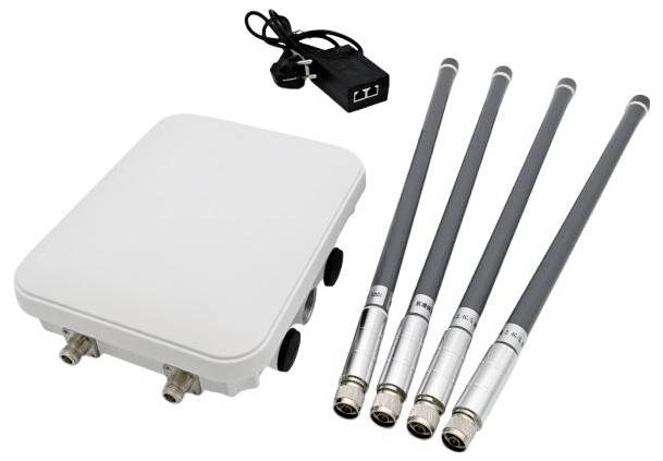 A wireless communication device with a white rectangular unit, four antennas, and a black power adapter.