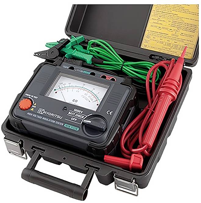 An open carrying case containing an analog insulation tester with probes and clips, displaying a voltage reading and instruction sheet.