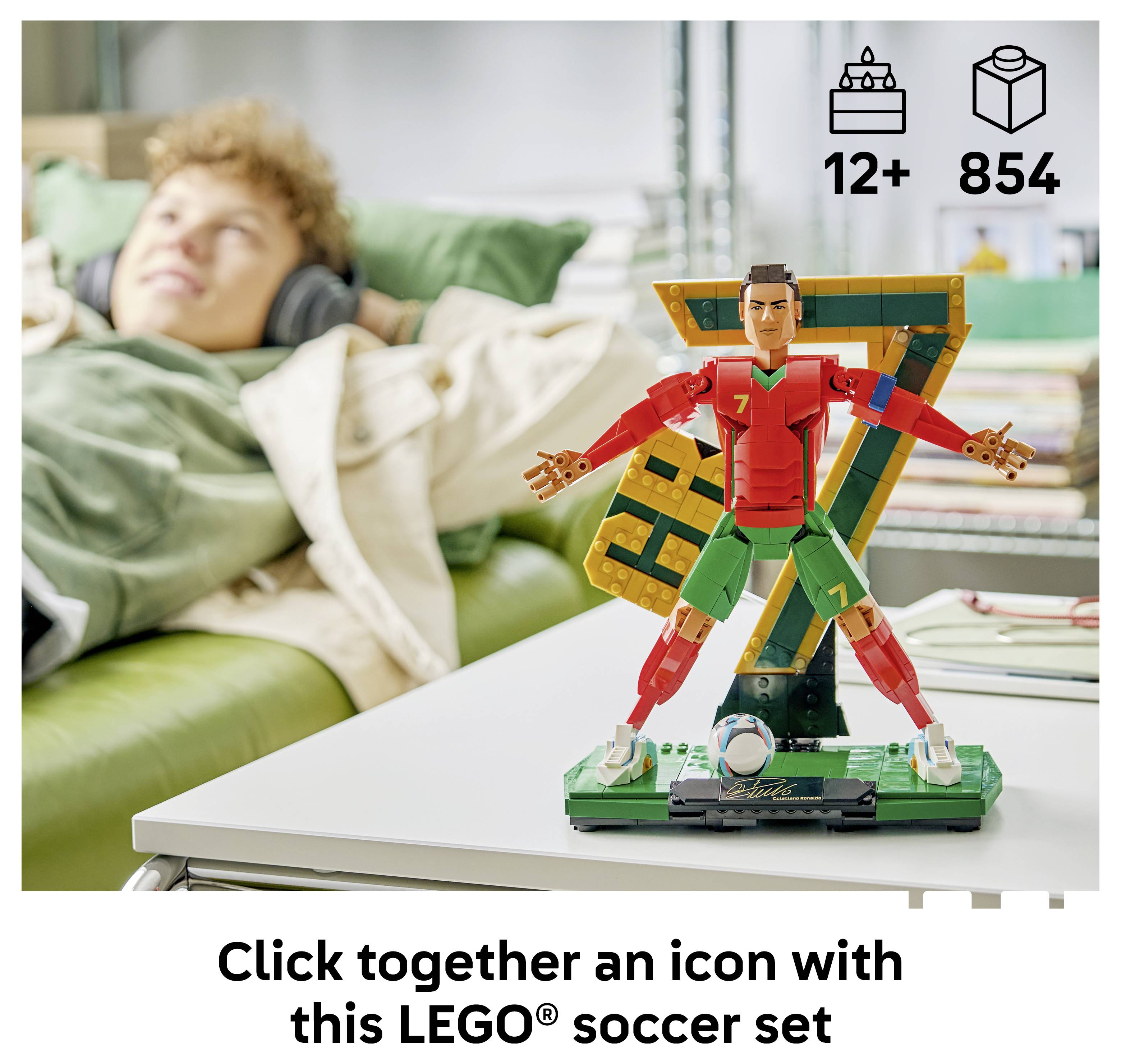 LEGO soccer set icon of a colorful soccer player, with '12+' and '854' pieces, shown on a table in front of a child resting on a couch.