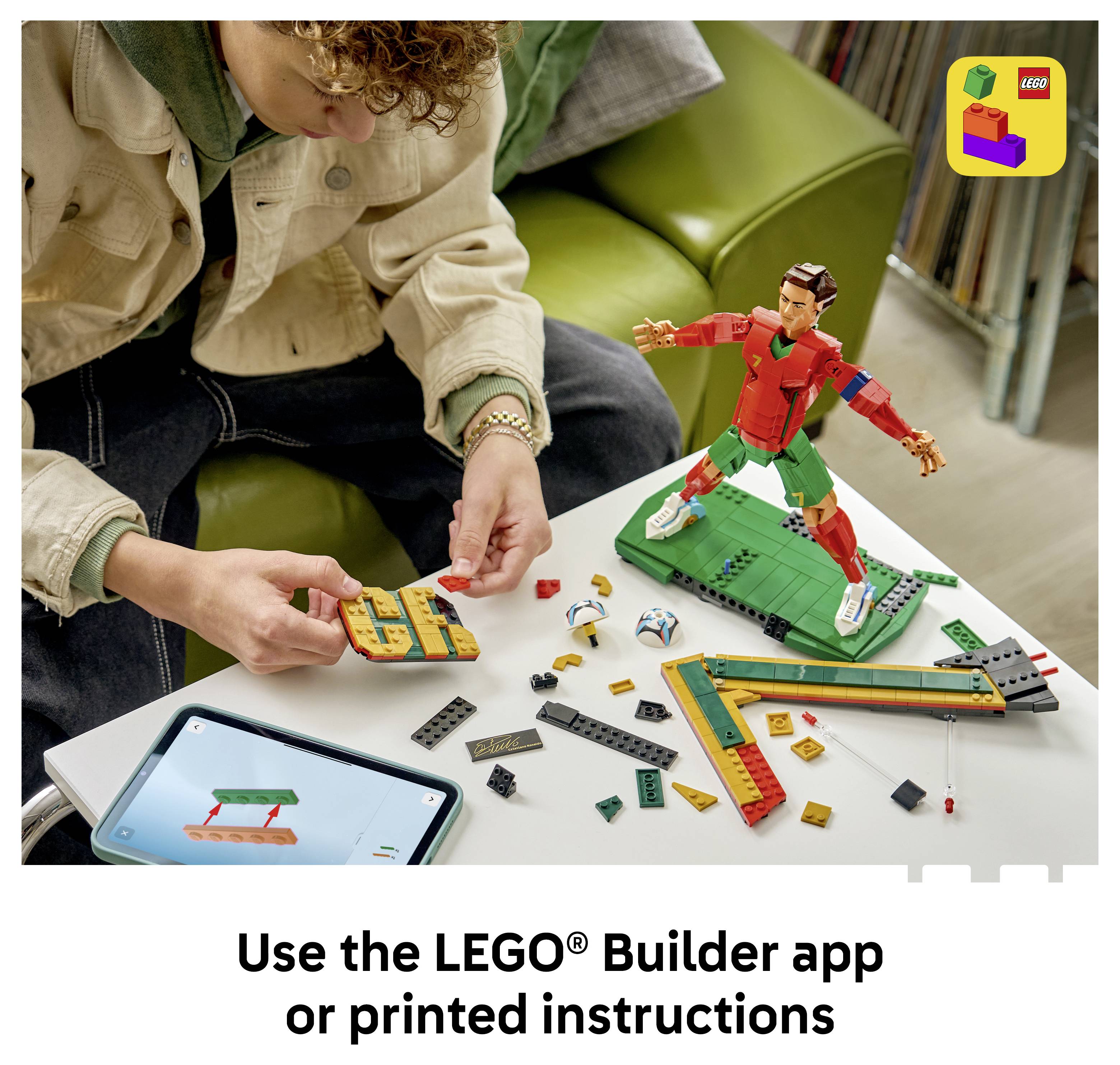 Person assembling a LEGO model on a table, with a completed figure nearby and a phone showing the LEGO Builder app; text says 'Use the LEGO Builder app or printed instructions'.