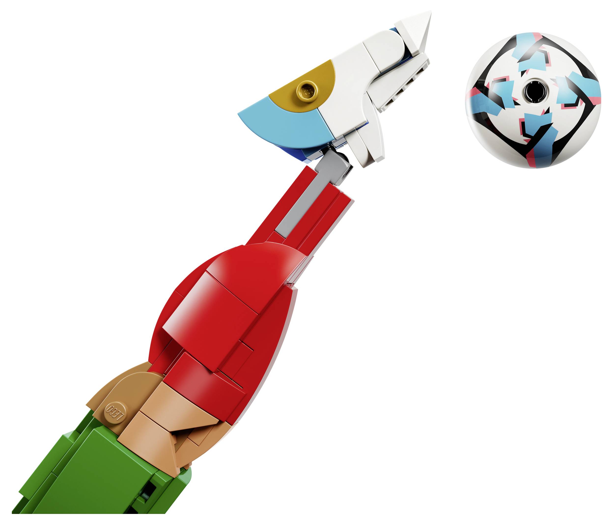 Close-up of a colorful LEGO-style robot arm or dinosaur head reaching toward a patterned ball on a white background.
