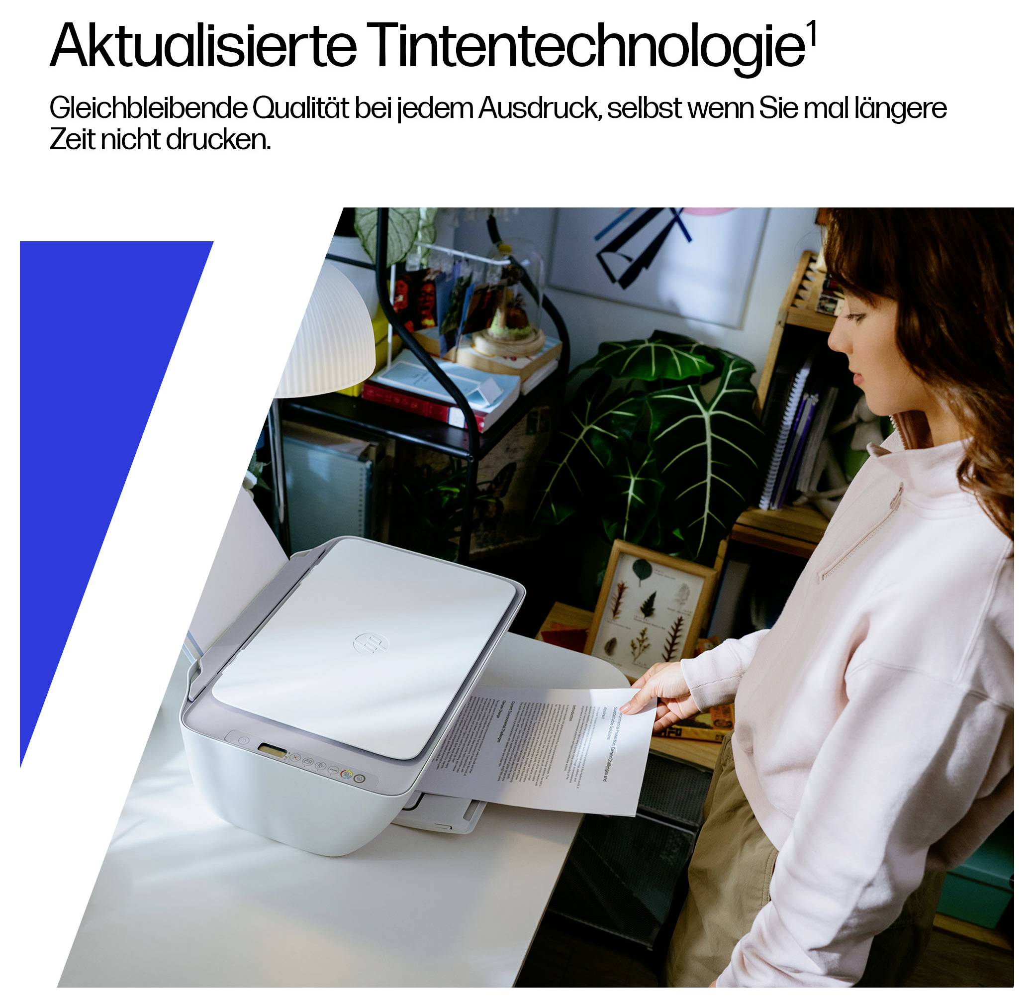 A person is operating a printer on a desk with plants and office supplies in the background. Text at the top: 'Updated ink technology'.