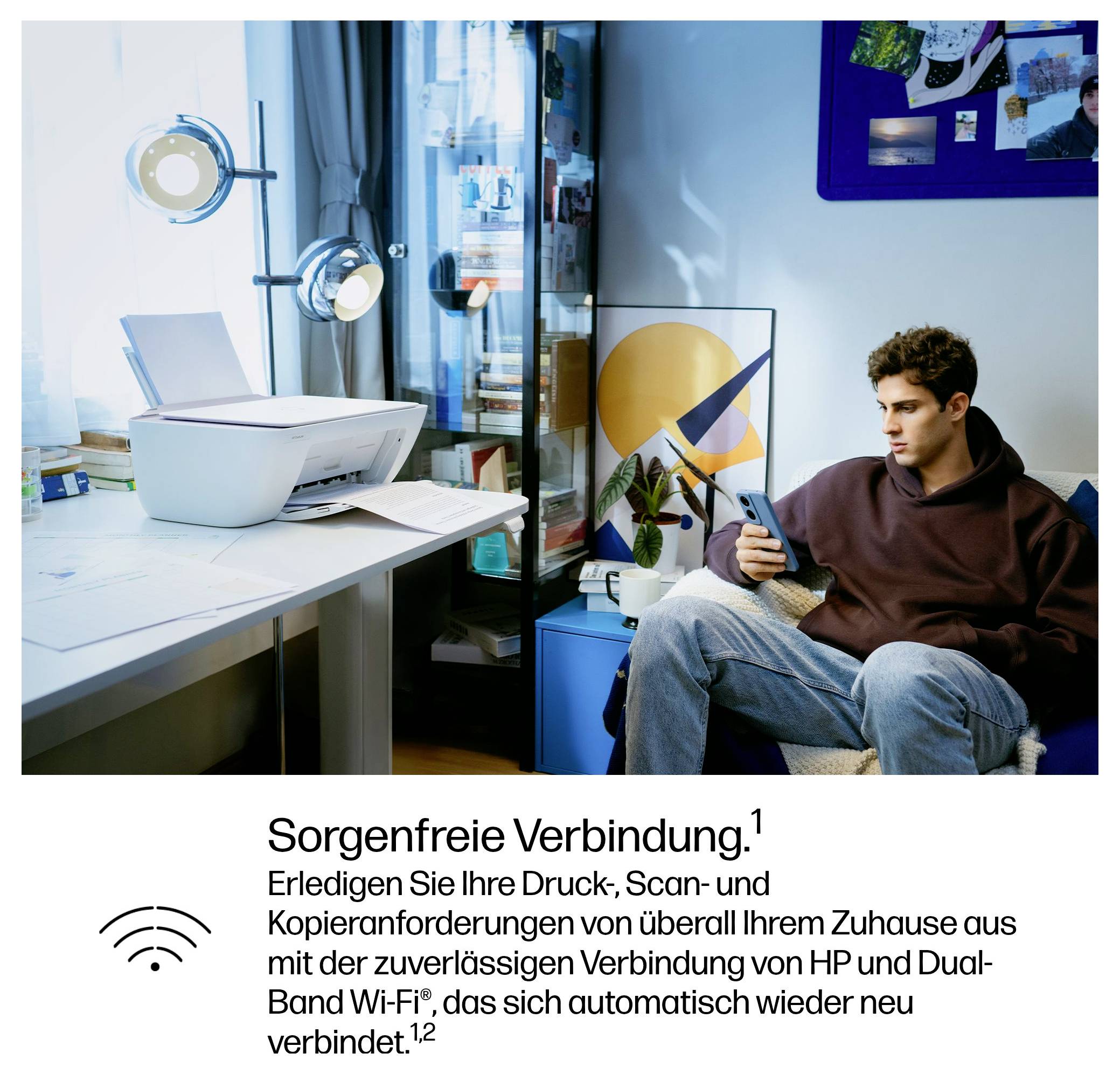A young man sits on a sofa with a smartphone. In the background a printer on a desk. Text: 'Worry-free connection'.
