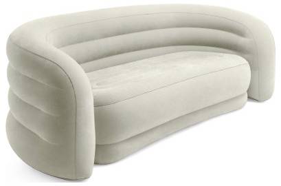 A light gray, modern curved sofa with a plush appearance and ribbed detailing on the backrest, suitable for contemporary living spaces.