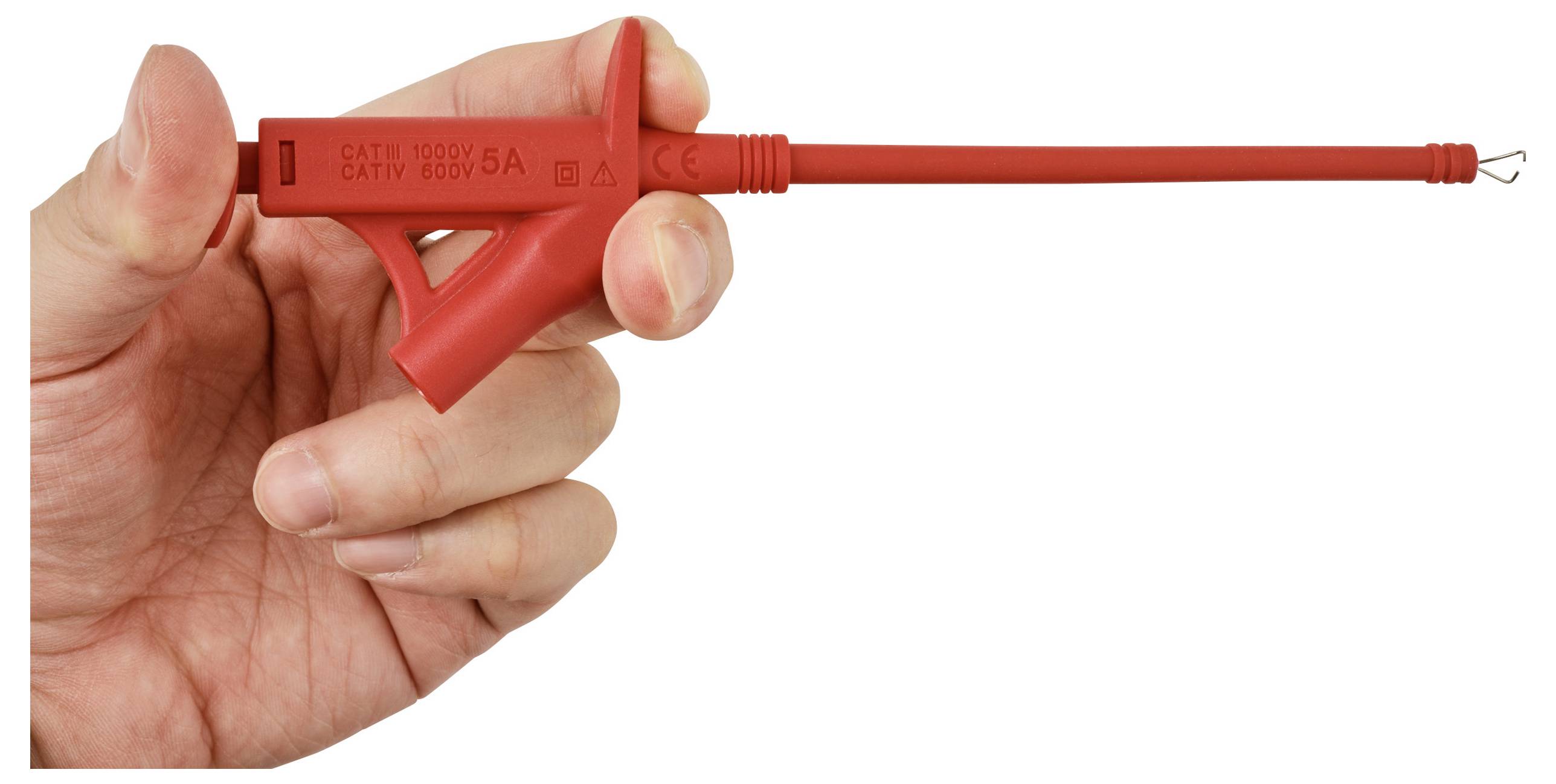 Hand holding a red clip-on electrical test probe with a pointed metal tip against a white background.