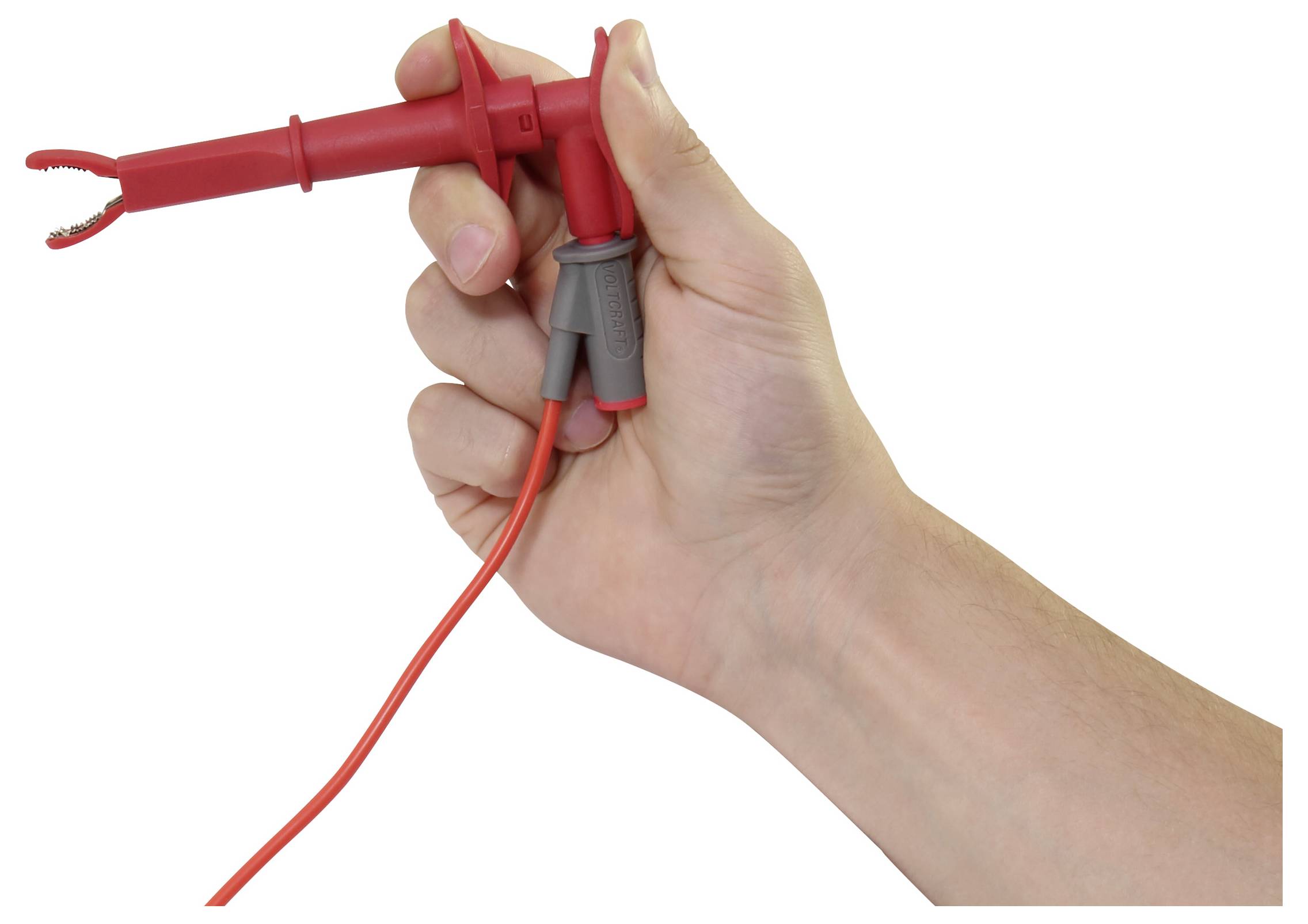 A hand holds a red multimeter test probe with an attached lead, shown against a plain white background.