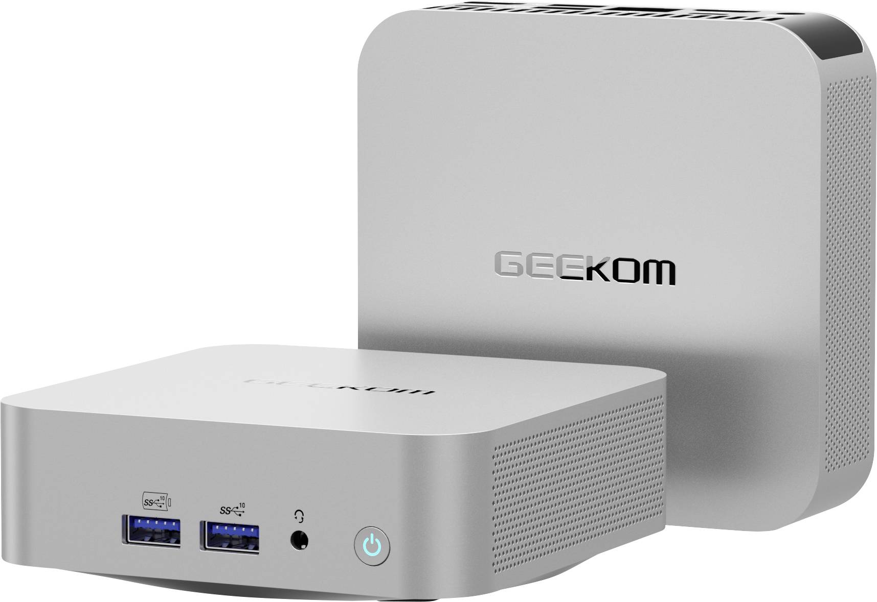 Two silver GEEKOM mini PCs shown at an angle, one front-facing with USB ports, audio jack, and power button; one standing behind it.