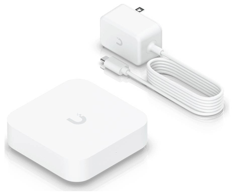 White square-shaped device with a small logo, paired with a charger and USB cable, used for connecting smart home devices.