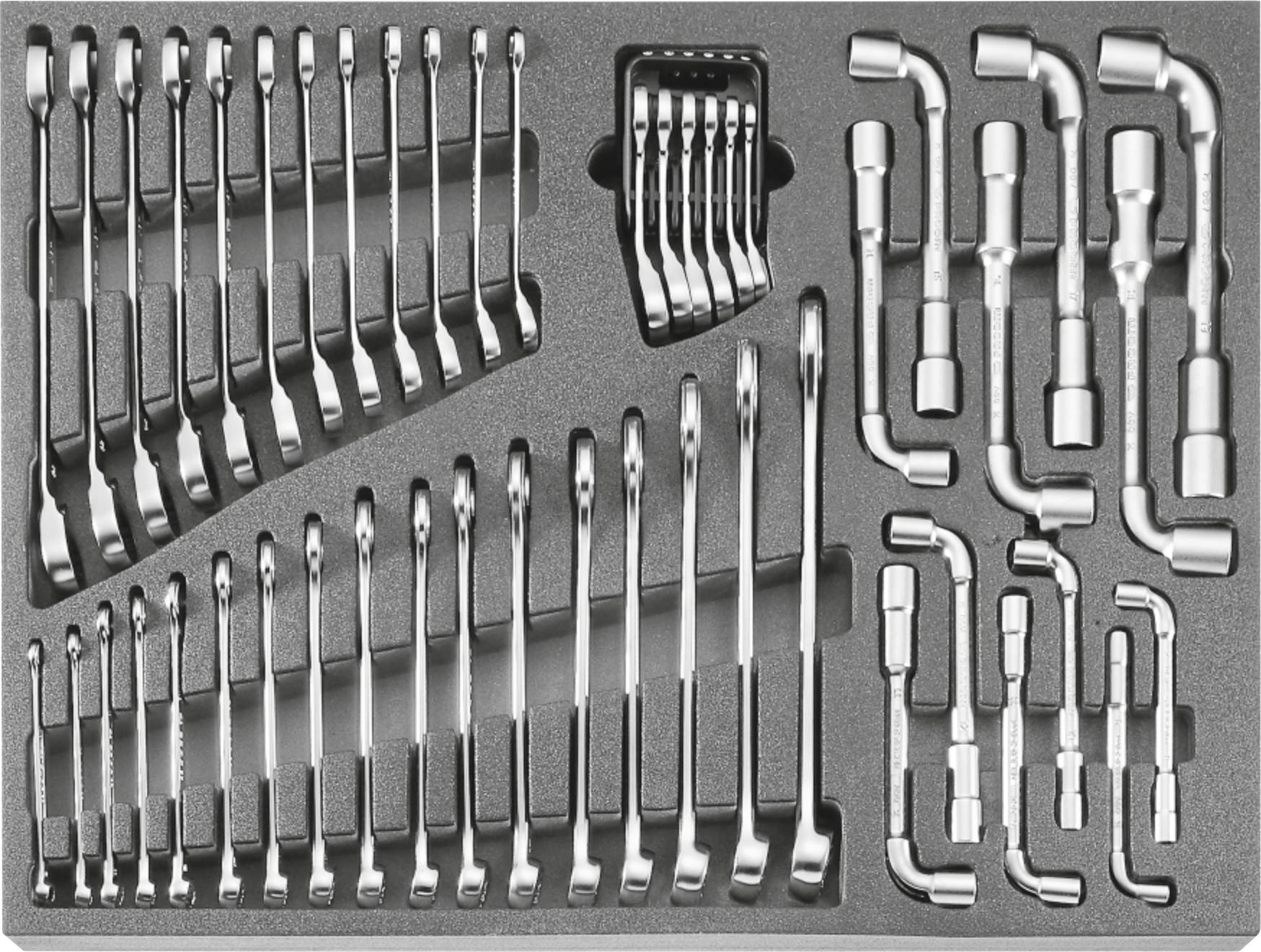 Metal wrench set in a foam case, with multiple open-end wrenches and socket attachments neatly arranged for storage.