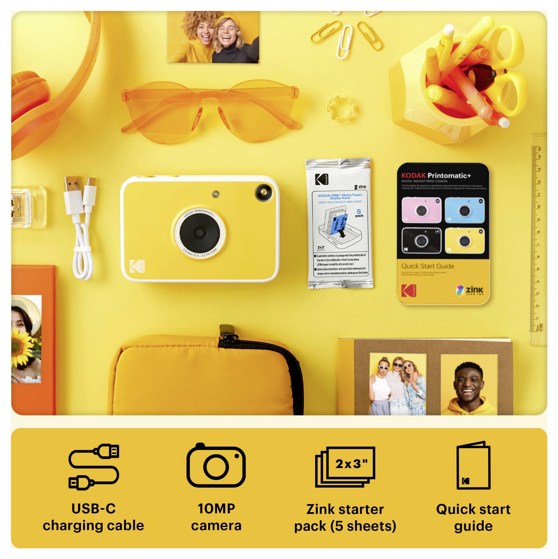 Yellow Kodak instant camera kit with USB-C cable, Zink starter pack, quick start guide, and accessories arranged on a bright yellow background.